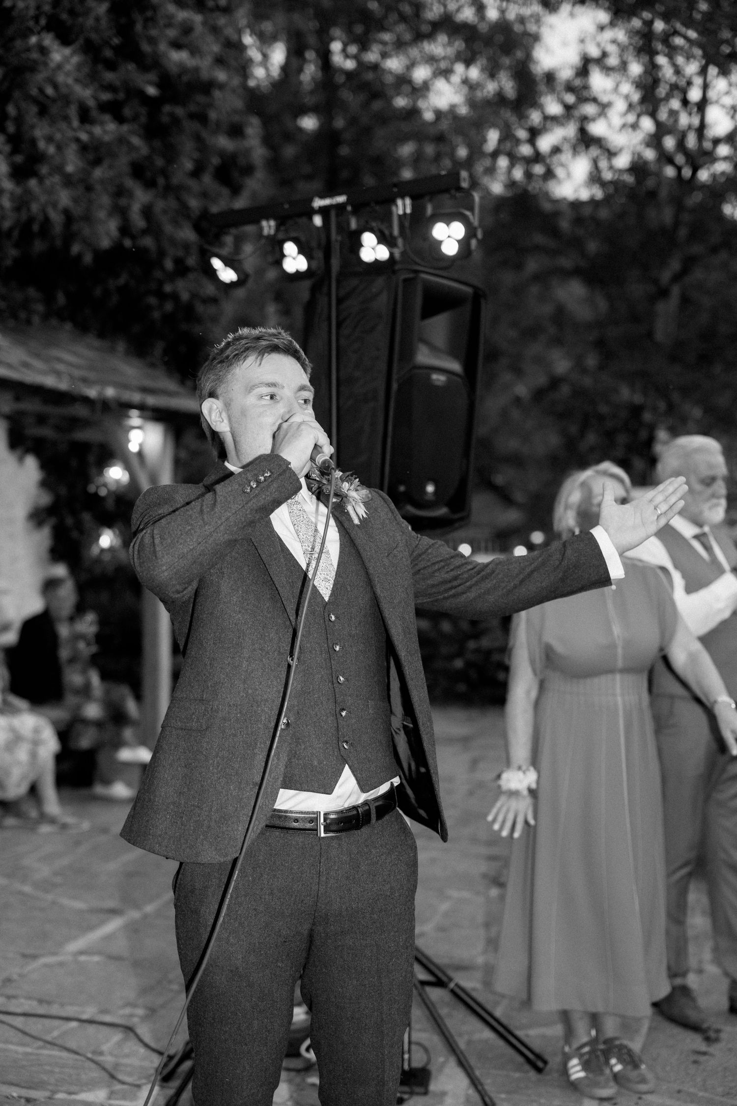 Black and white photos of wedding guests dancing at outdoor evening reception.