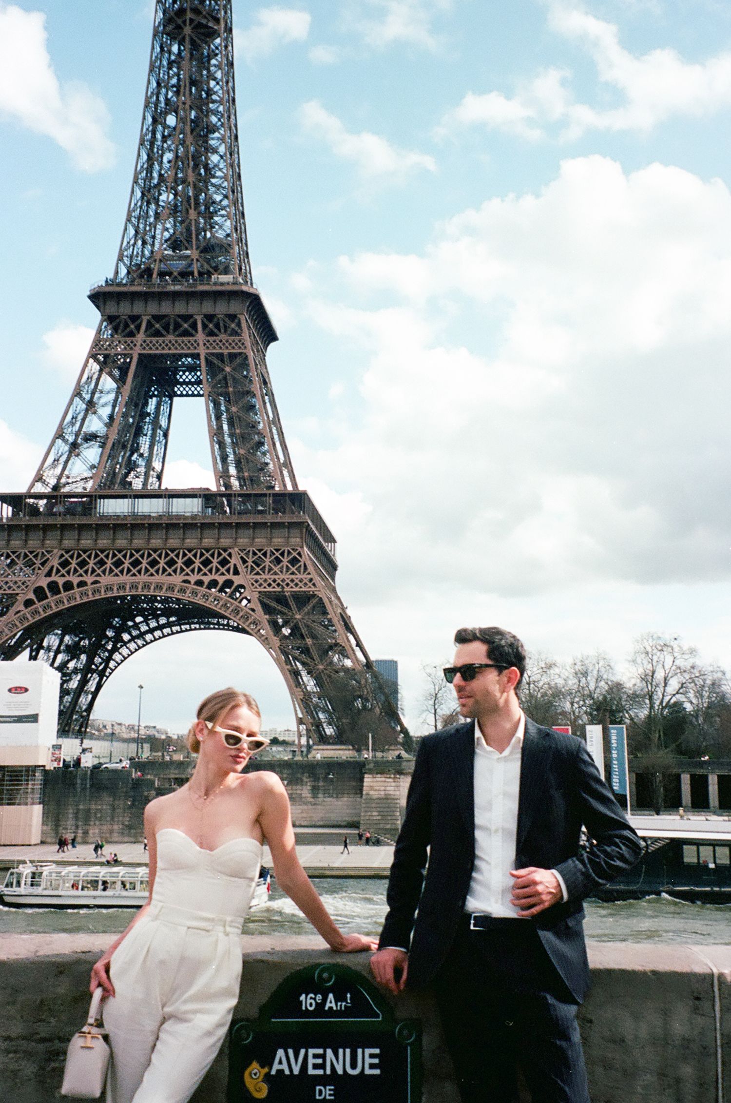 A couple poses romantically in front of the Eiffel Tower in Paris for a series of wedding photos.