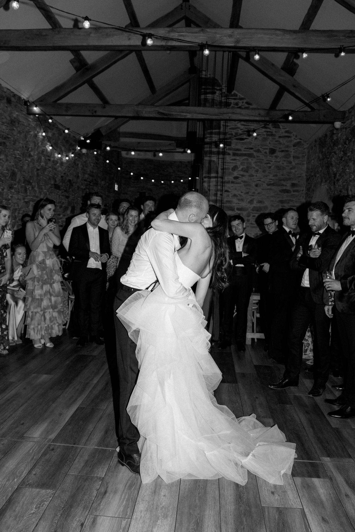 Dancing couples fill the dance floor during an evening wedding reception.