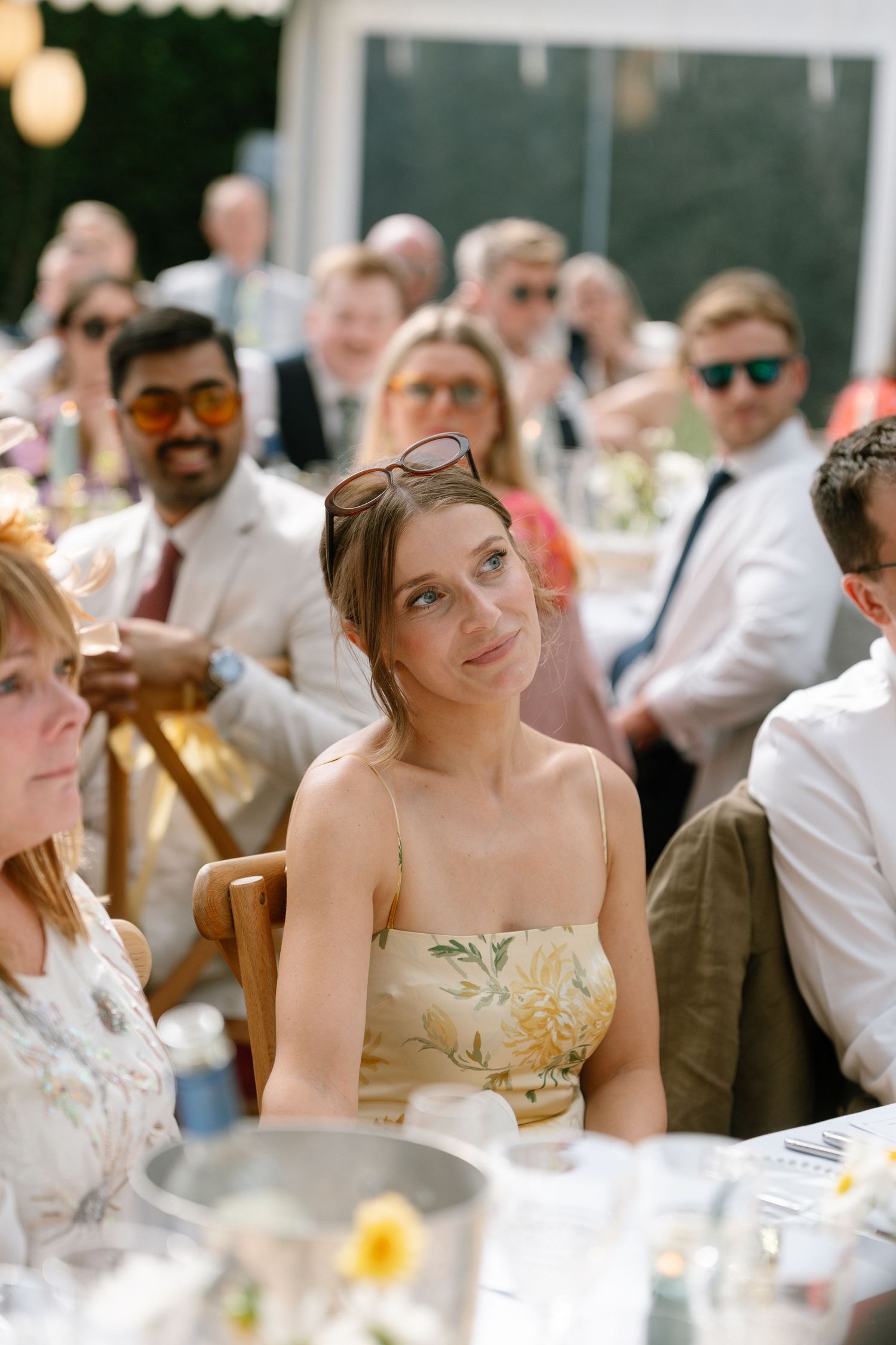 Wedding guests sharing laughter and joy during an outdoor reception celebration.