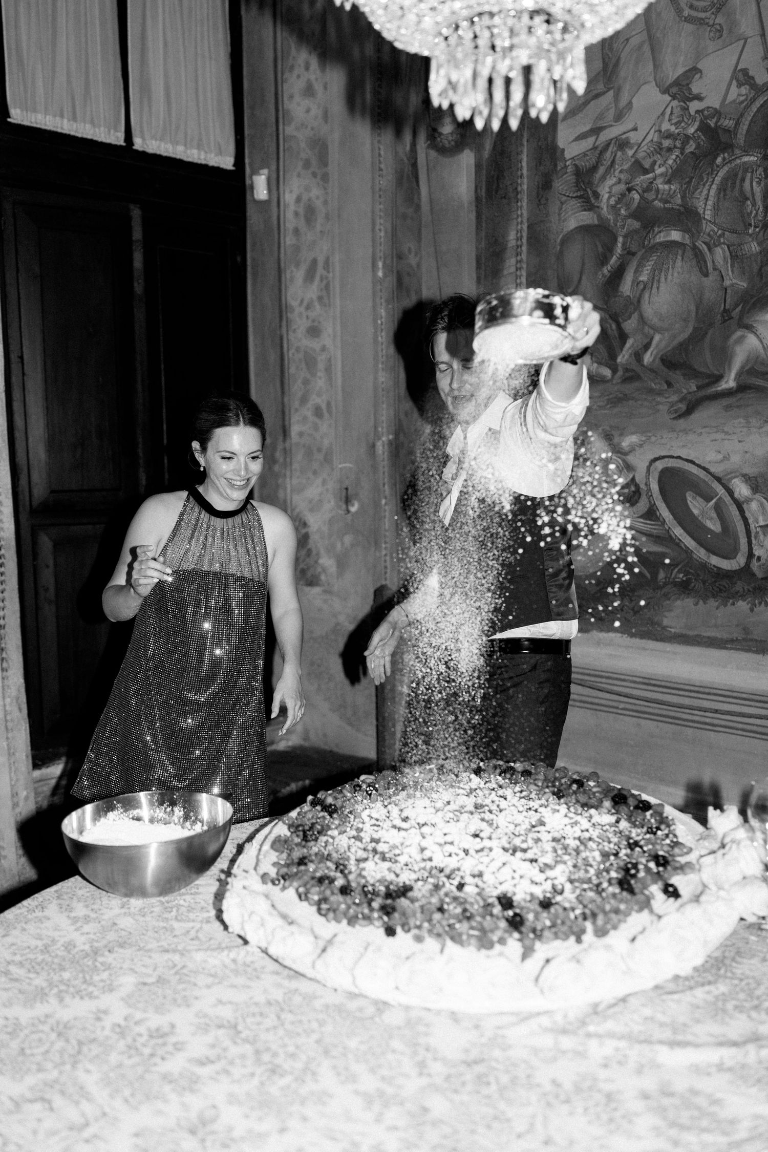 White powder or flour being thrown and splashed during a festive celebration indoors.