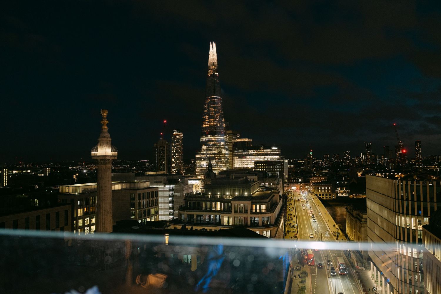 Panoramic view of London's skyline at night with St Paul's Cathedral visible.