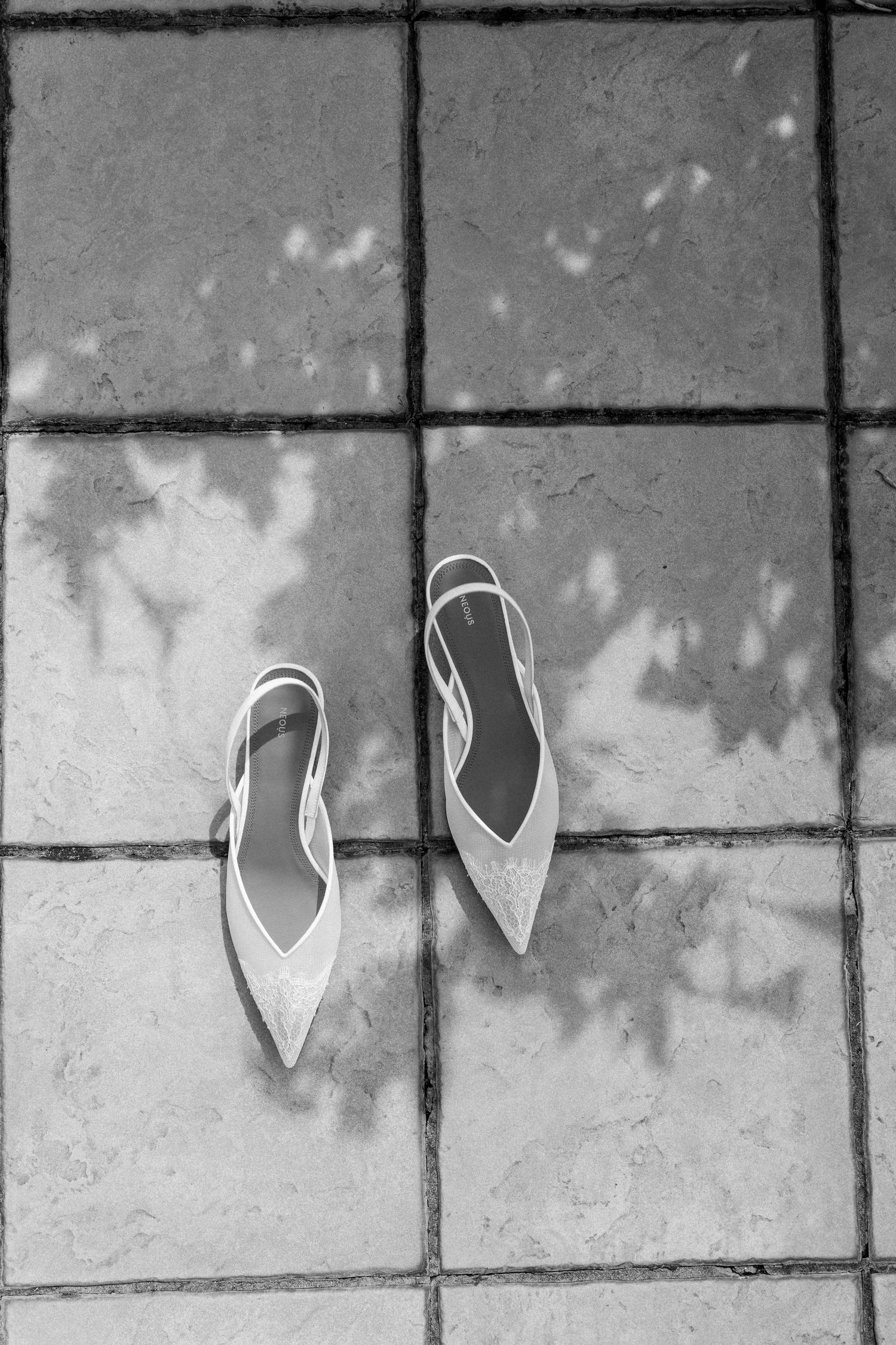 Abstract white heart shapes arranged on a grey textured wall.