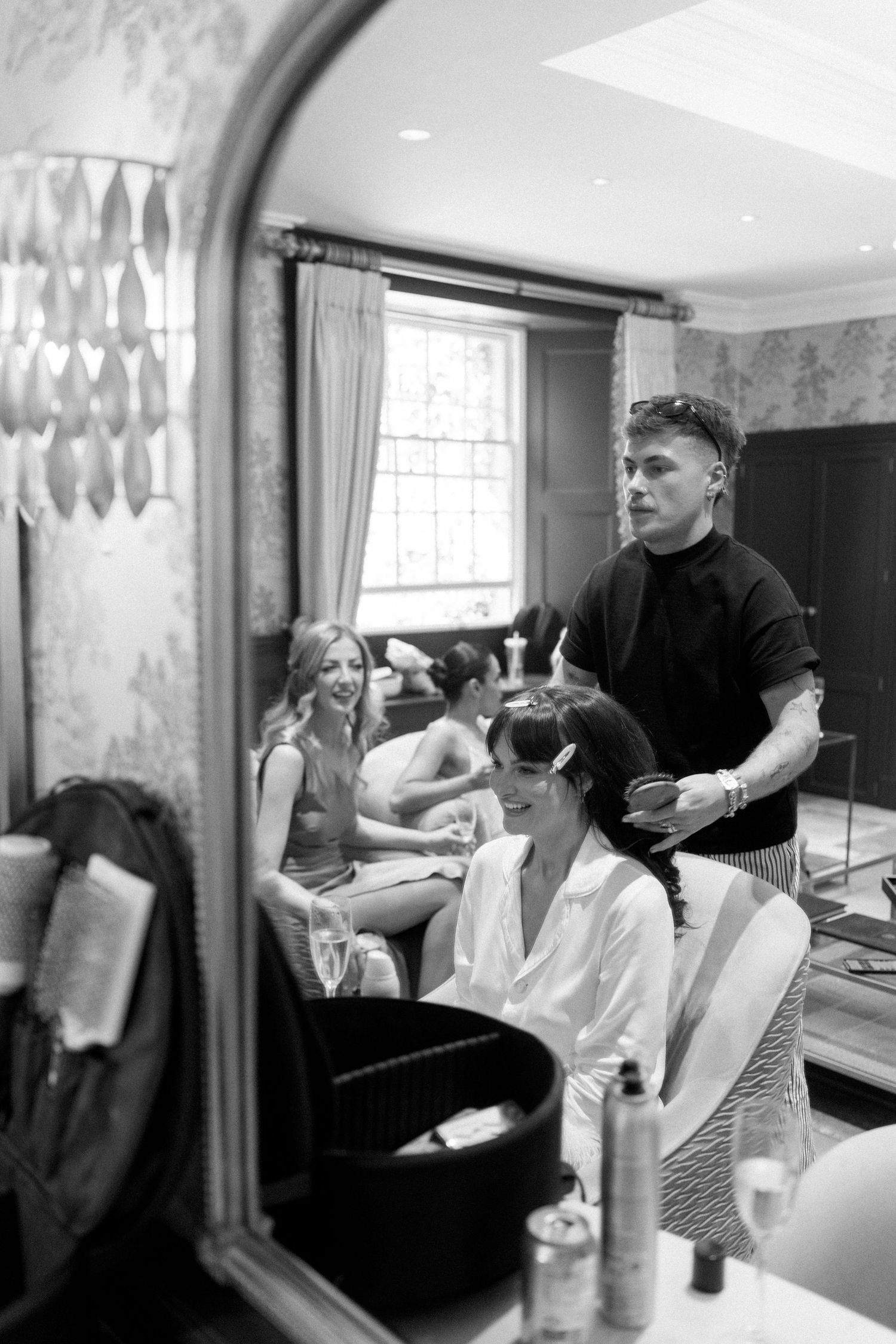 Professional hair styling taking place in elegant salon interior.