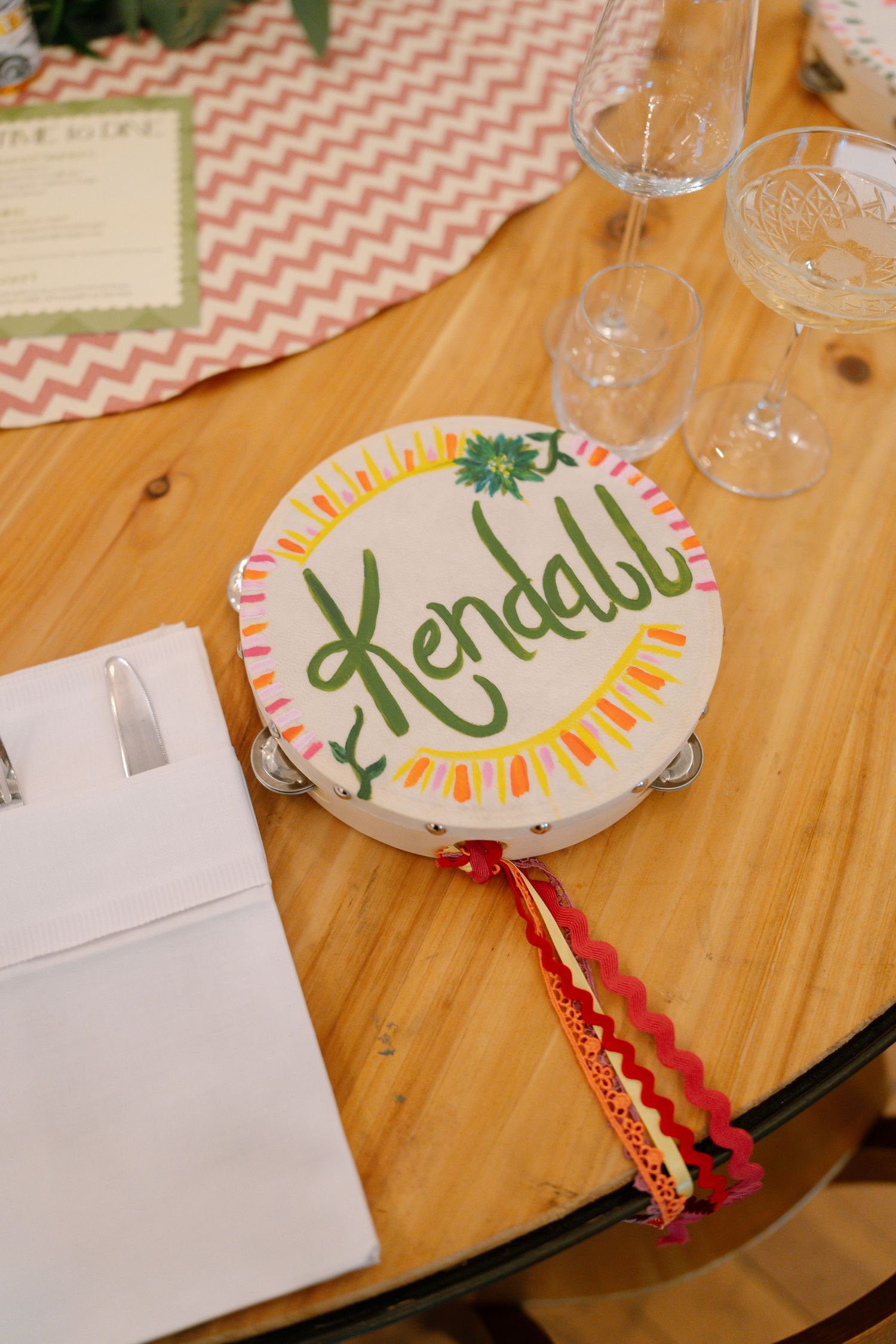 Decorative name cards with chevron patterns and colorful designs displayed on a wooden table.