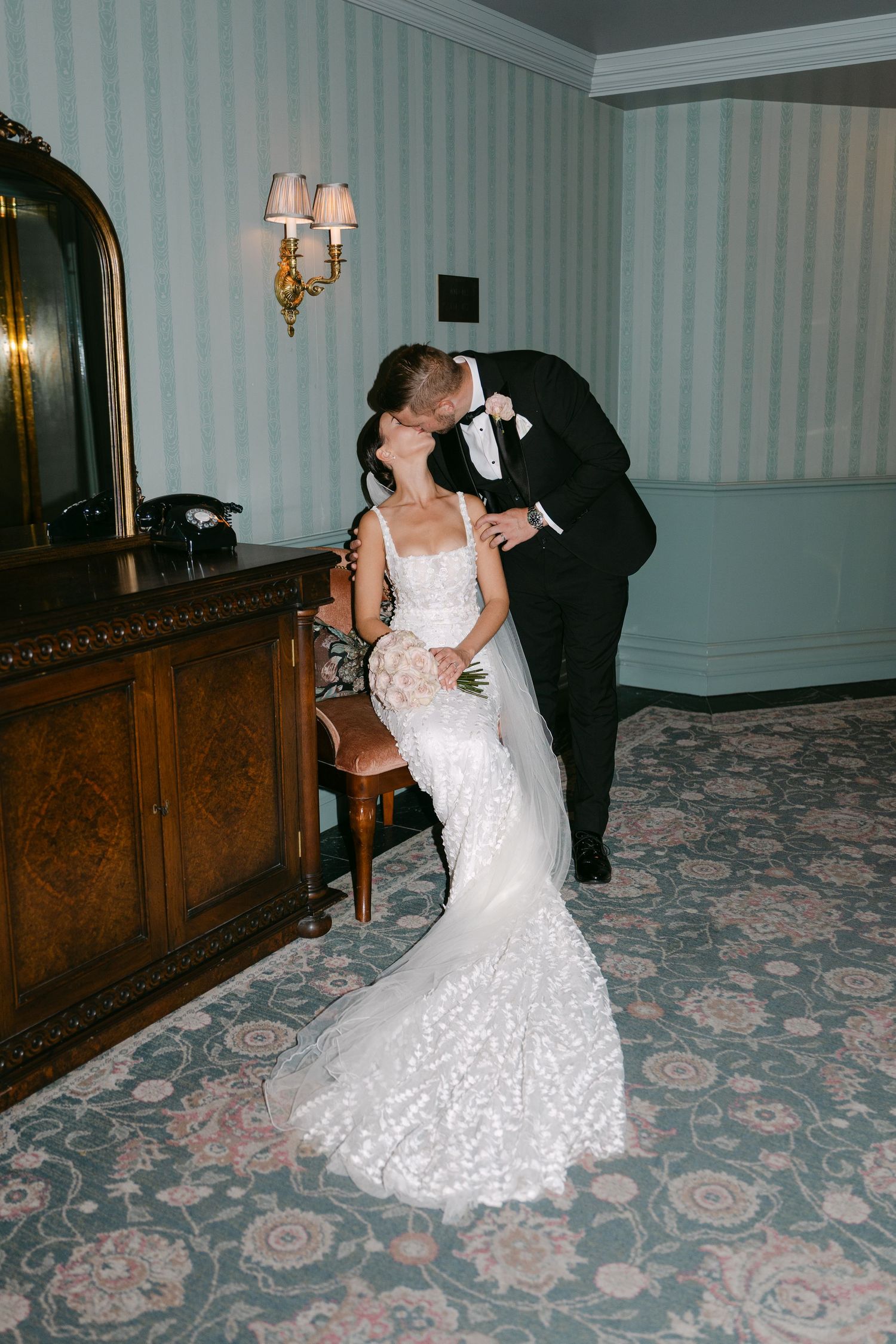 Romantic dance poses between newlyweds in hotel hallway.