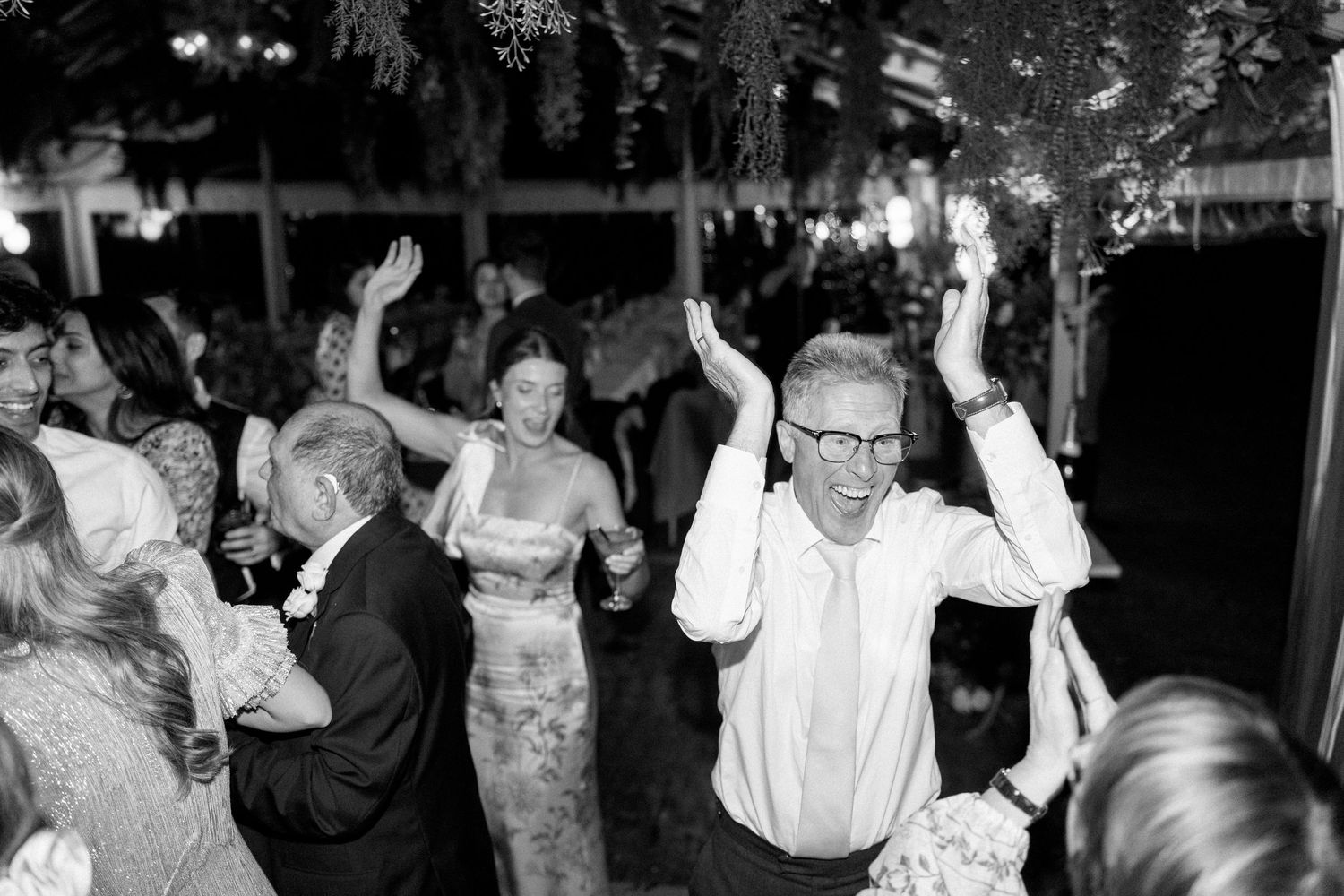 Guests dancing and celebrating at a lively wedding reception.