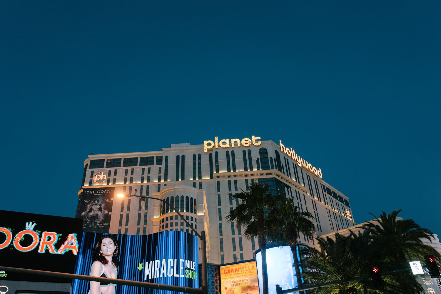 The Planet Hollywood hotel and casino illuminated at night in Las Vegas.
