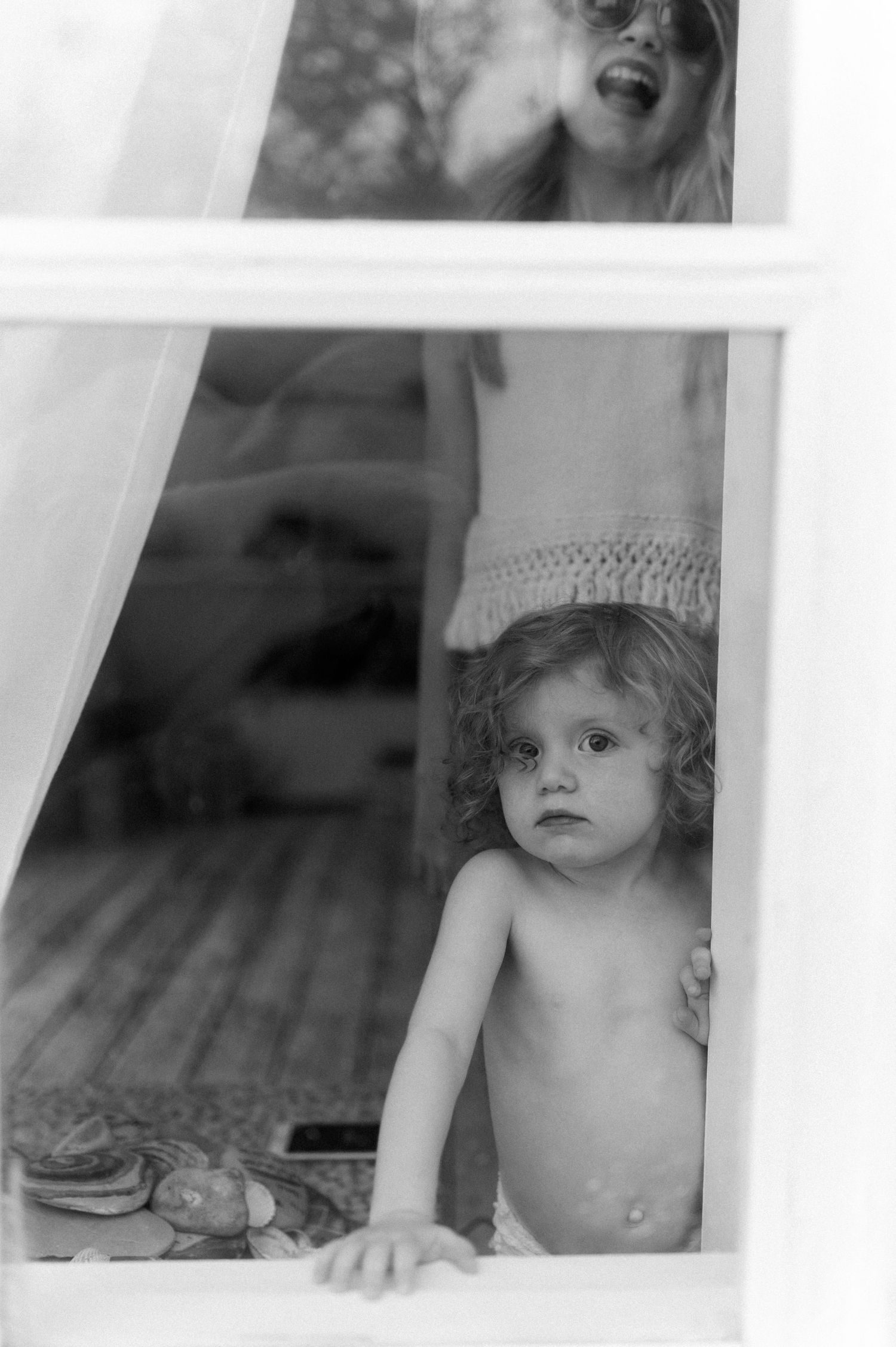 Black and white photo showing a view through multiple window panes.