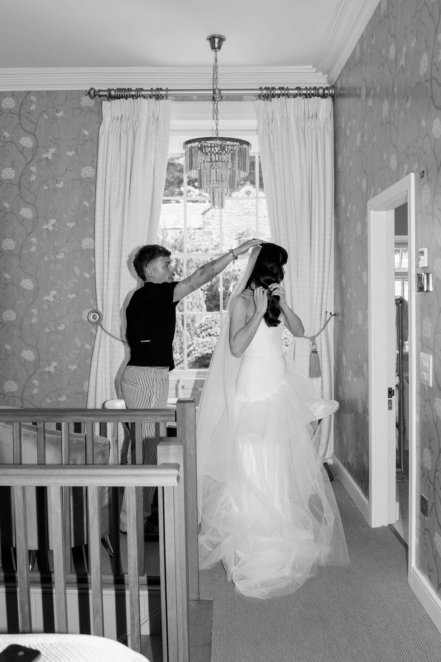 Sequential images showing movement and dance in a hallway with decorative wallpaper.