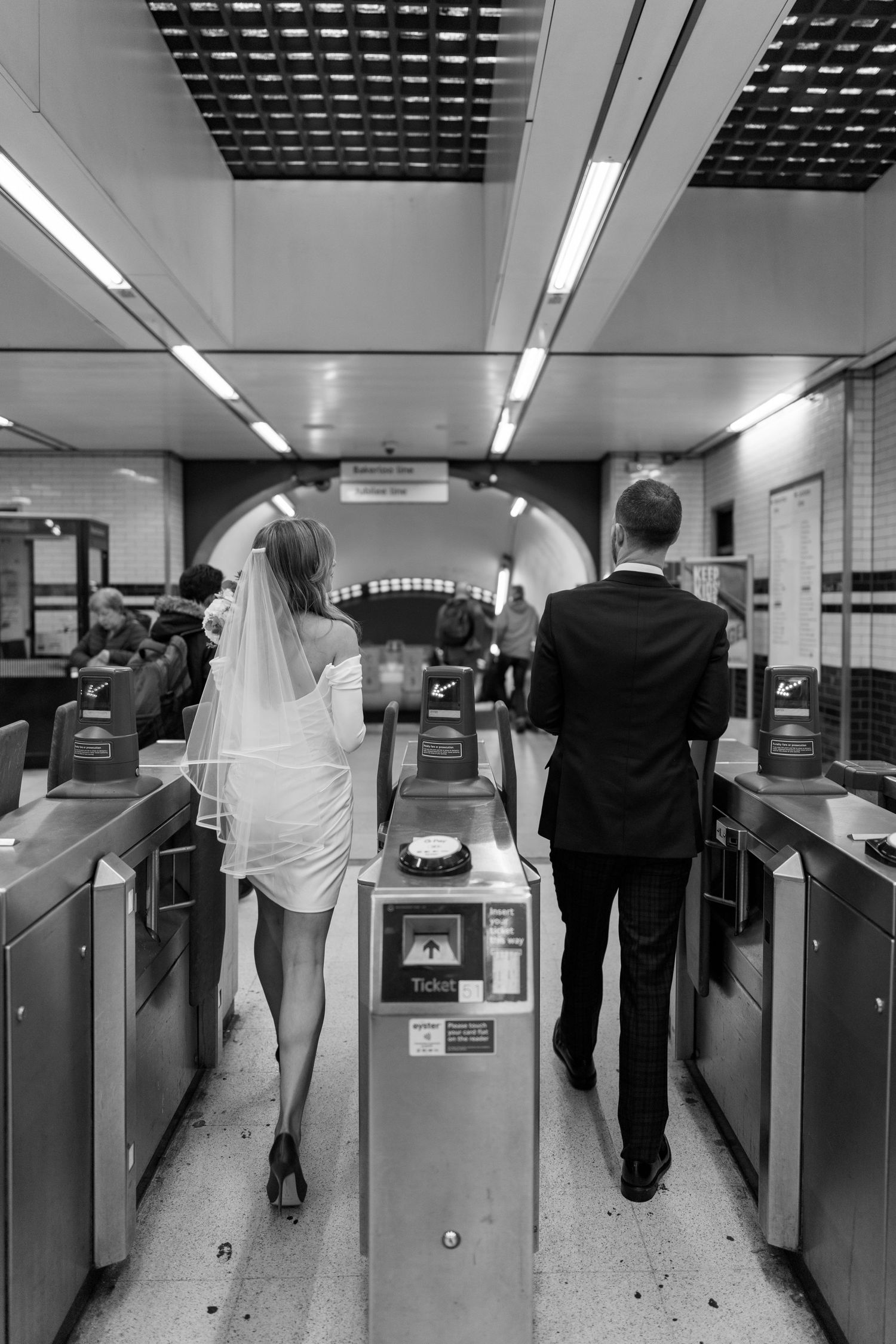 A series of black and white photos showing a couple walking through an office space with copy machines.
