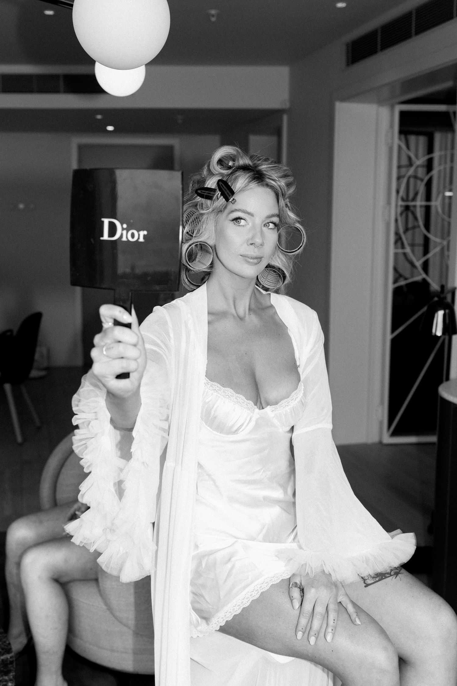 Black and white photos showing preparation in a bridal suite with Dior branding.
