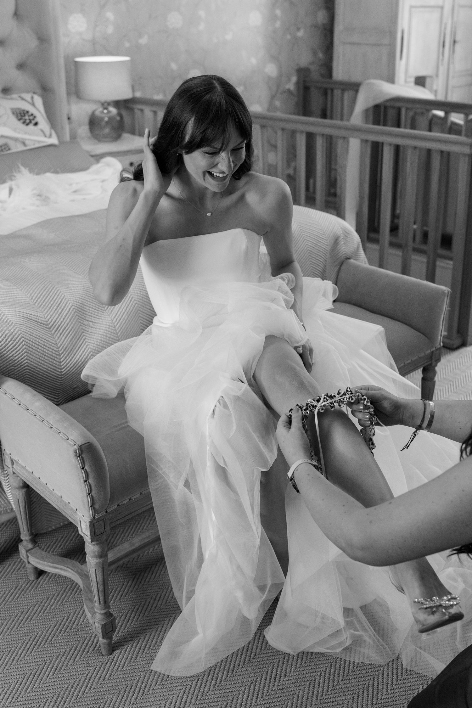 Series of artistic black and white photos showing movement of a flowing white dress on furniture.