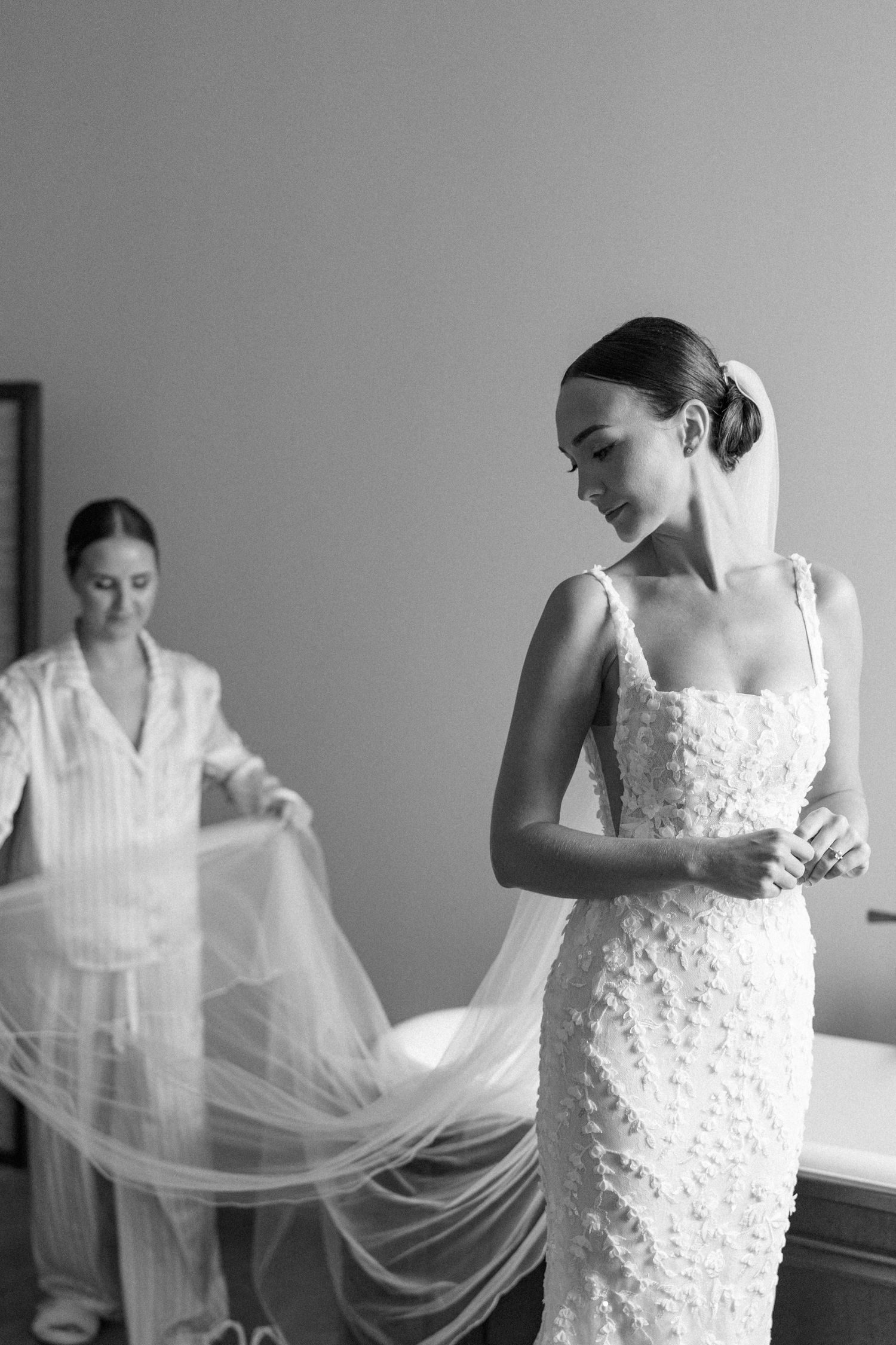 Sequence showing details of a white lace wedding dress with delicate floral appliques.