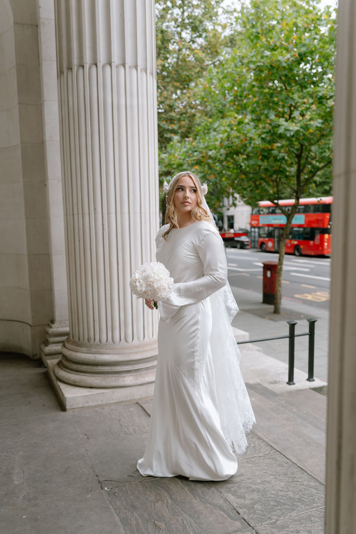 Wedding photography sequence showing white dress movements between classical stone columns outdoors.