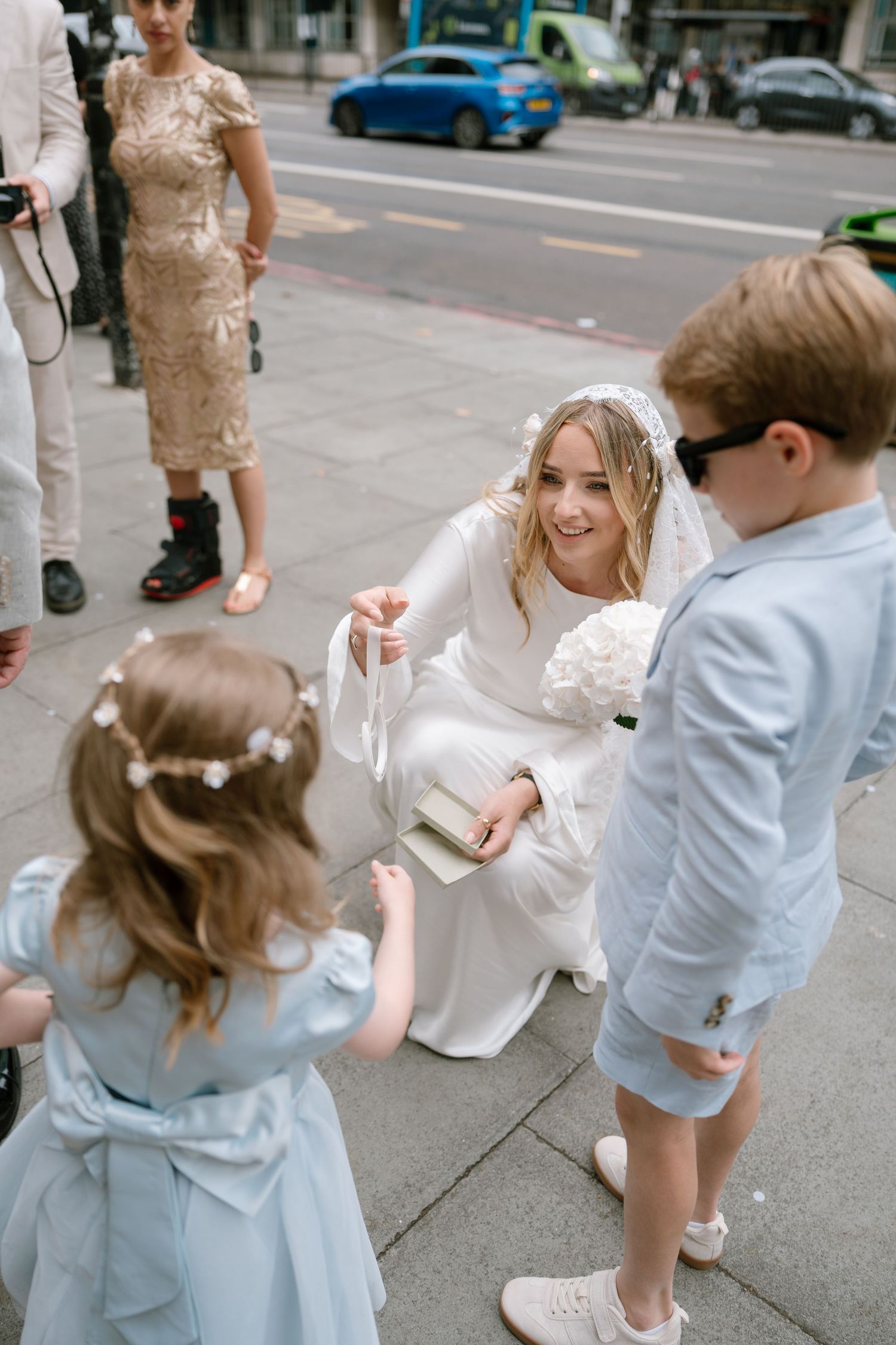 A playful street scene with people in white and blue outfits sharing a joyful moment.
