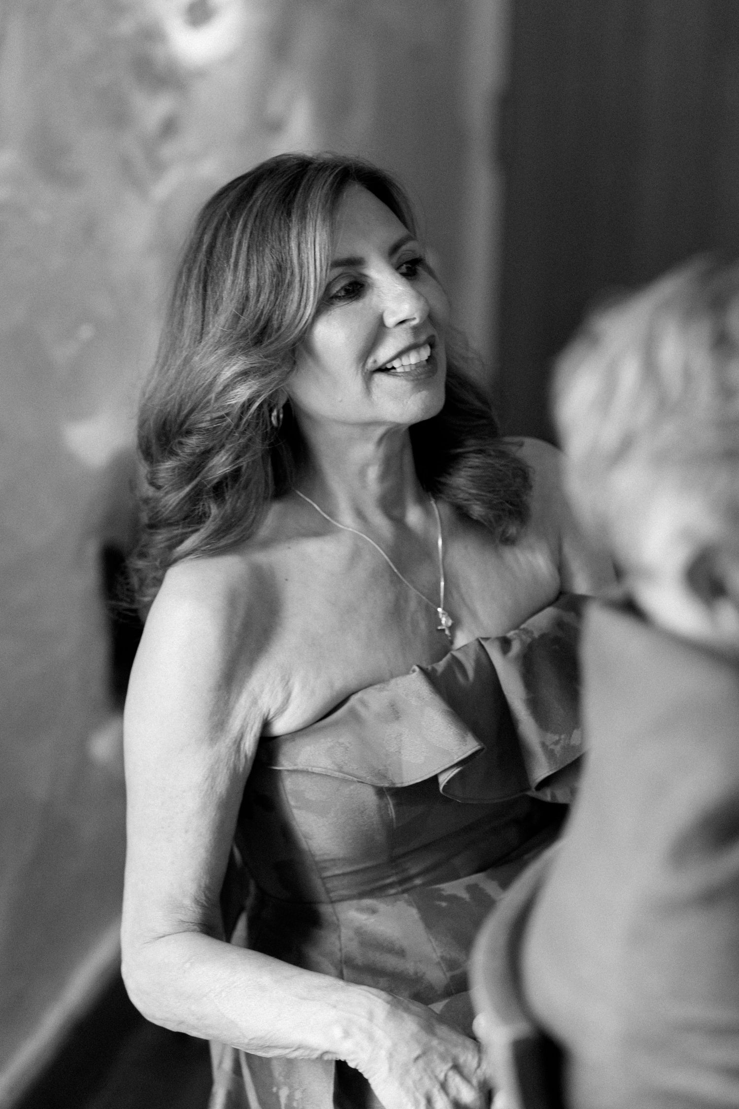 Black and white photo sequence of people dancing and laughing at a celebration.