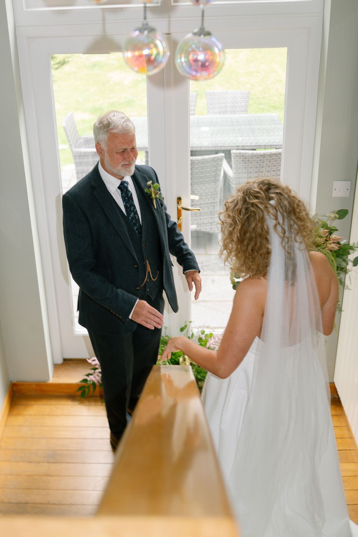 A wedding first look sequence in a bright indoor space with large windows.