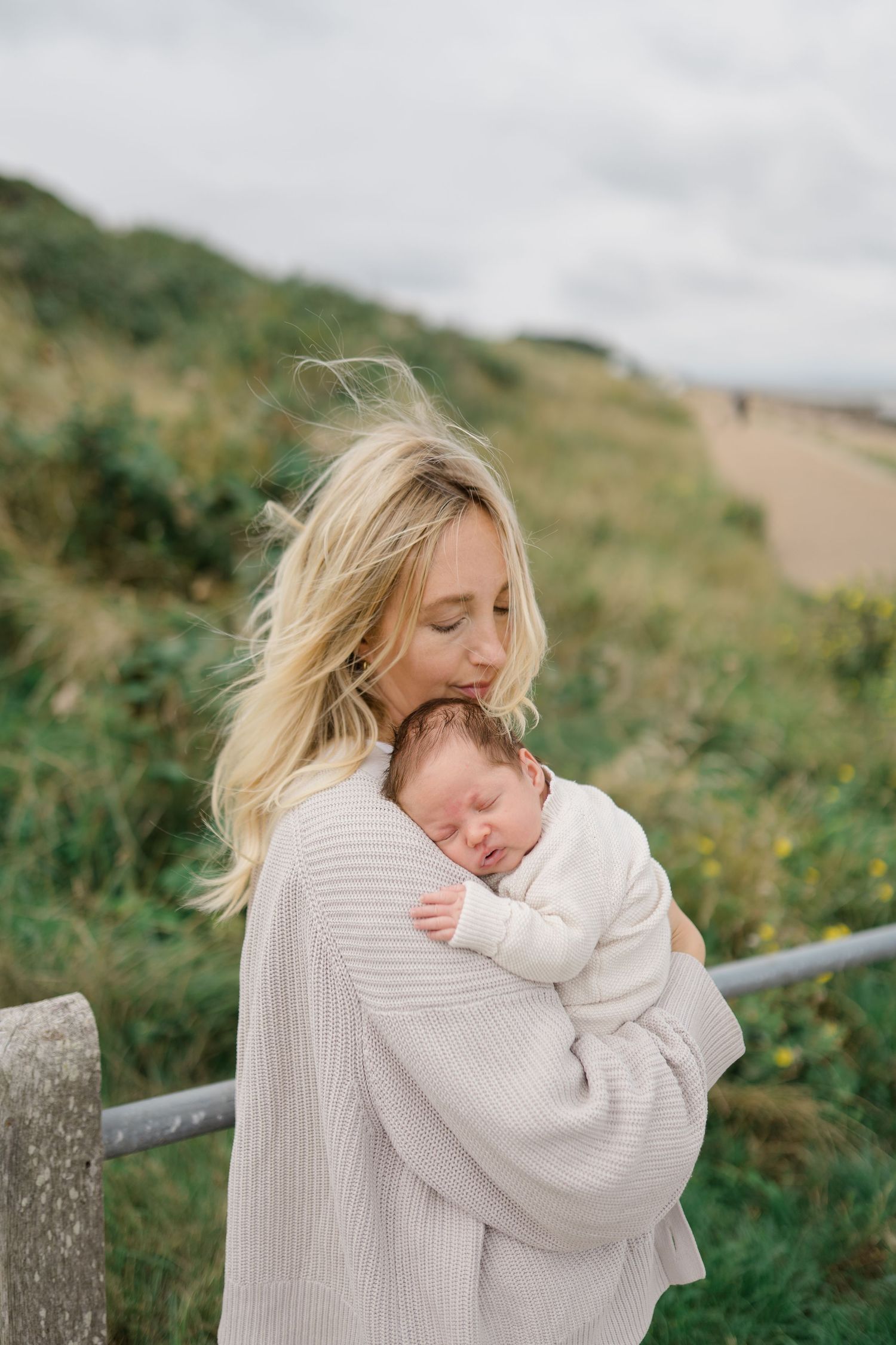 A sequence of outdoor photos showing an intimate embrace between parent and child against a natural hillside backdrop.