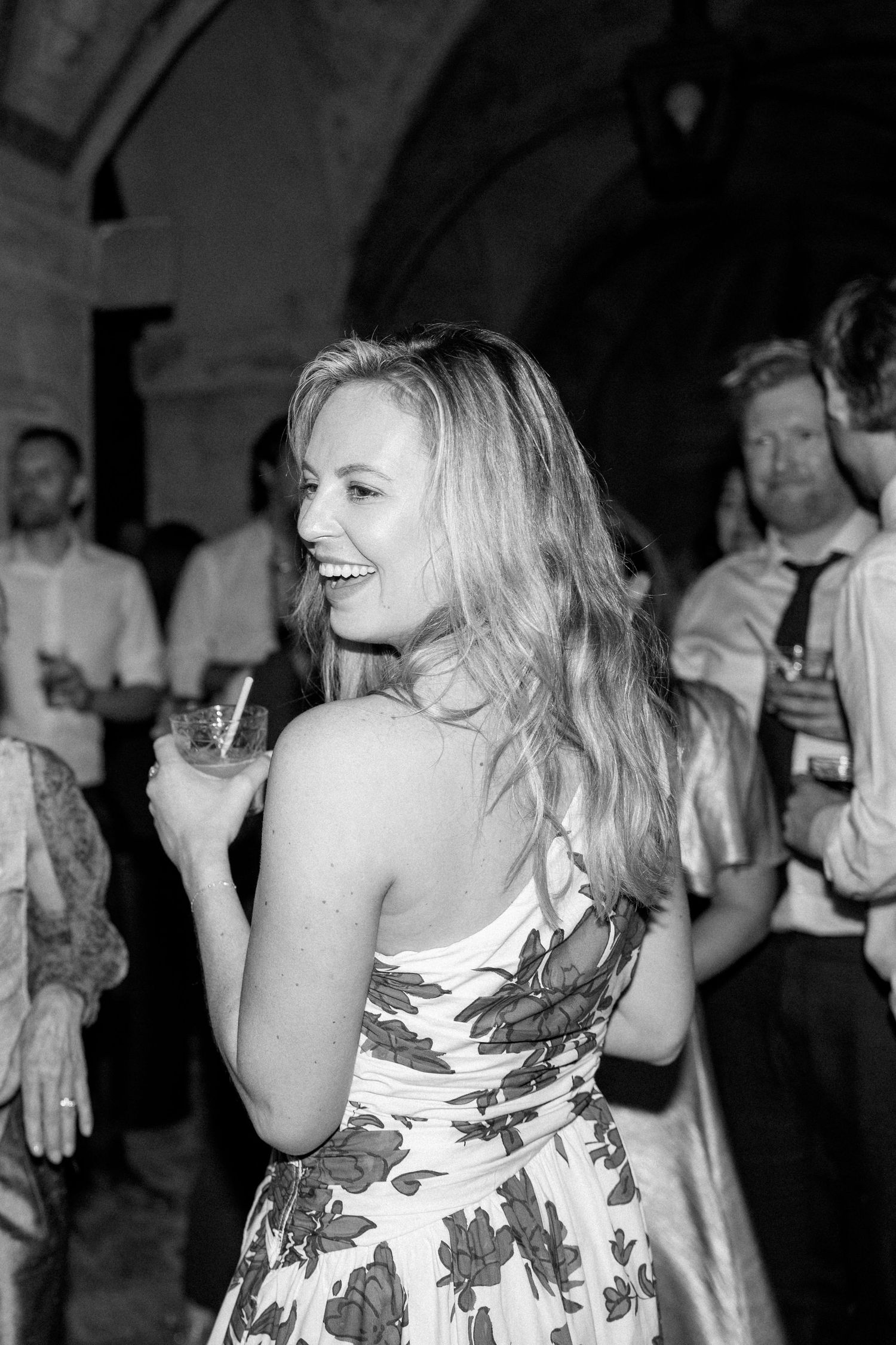 People dancing and laughing at an elegant evening celebration.