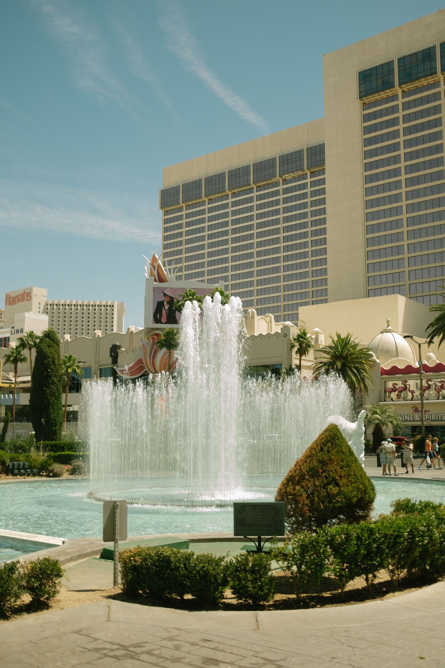 Luxurious fountain display outside Las Vegas casino with water jets and landscaping.