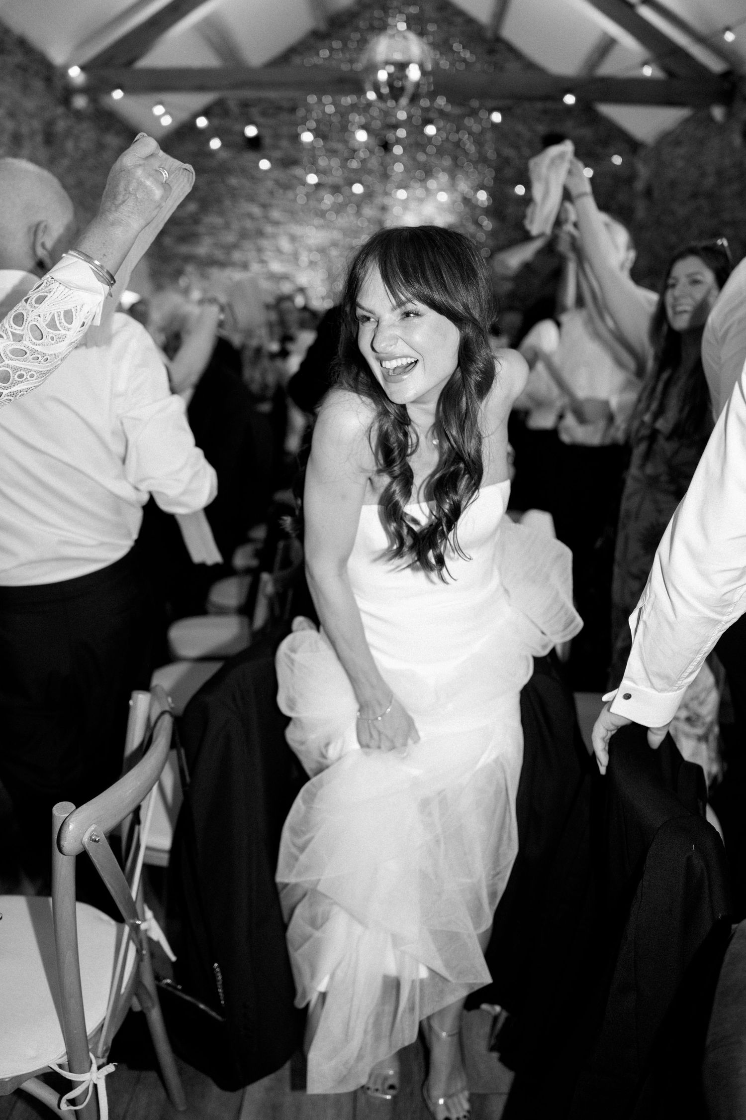 Joyful dancing moments captured at rustic wedding reception.