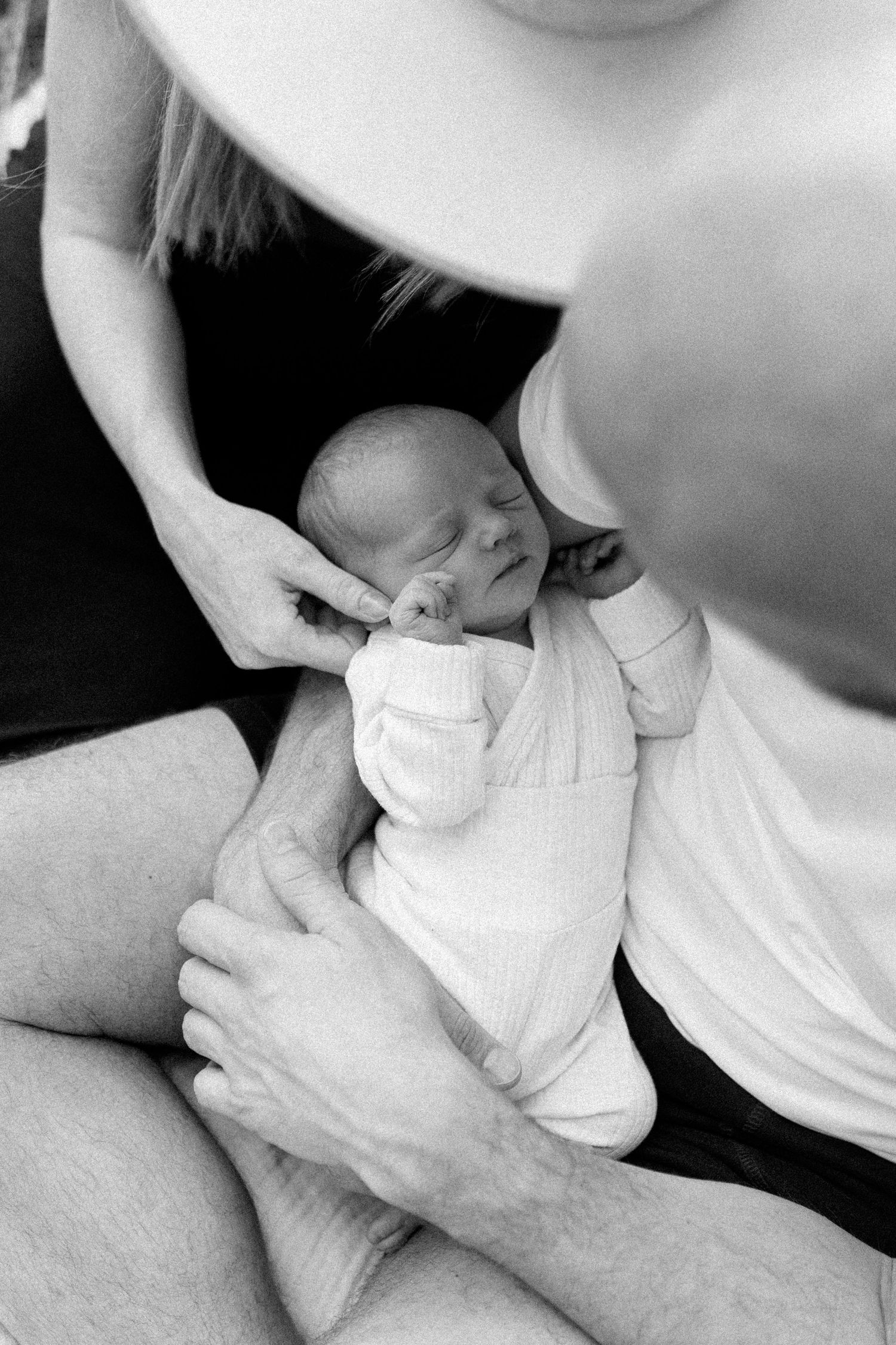 Close-up shots of gentle hands holding and caring for a newborn baby.