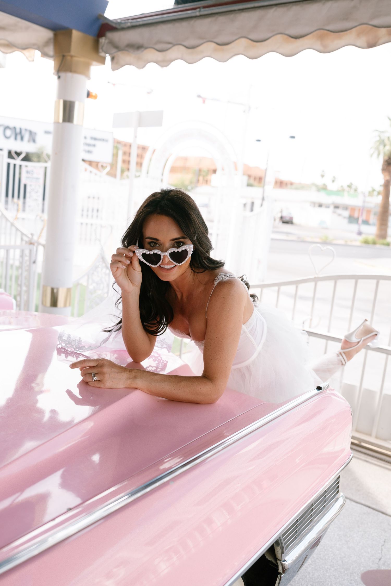 A playful photo series with a pink classic car at a retro-style venue.