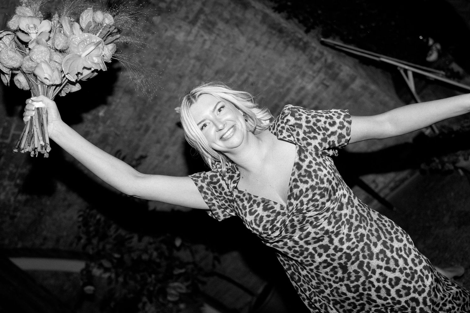 Black and white photos of party guests dancing and celebrating in leopard print and formal wear.