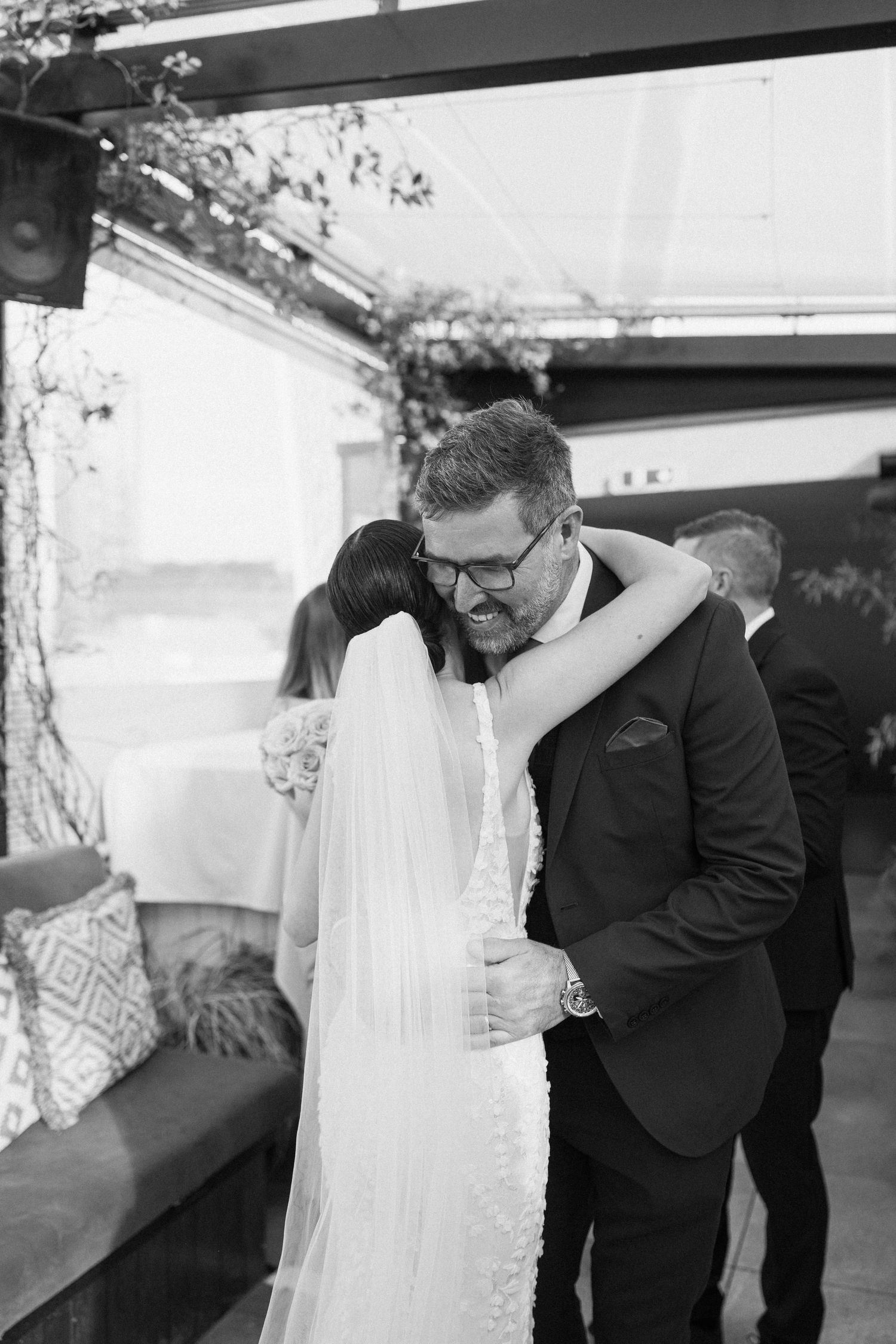 An intimate black and white wedding moment captured indoors.