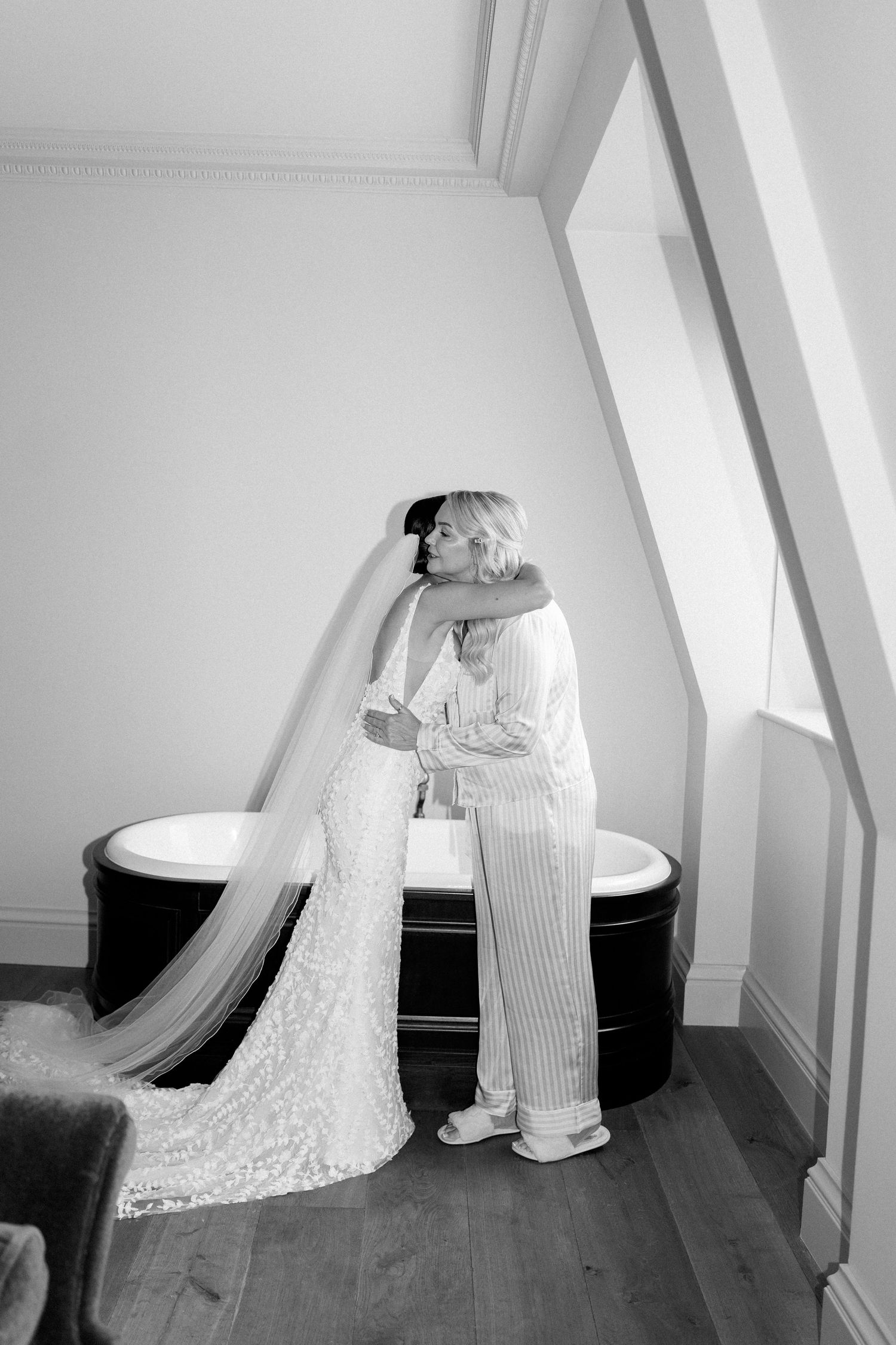 Wedding dress detail shots with vintage bathtub and hardwood floors in attic space.
