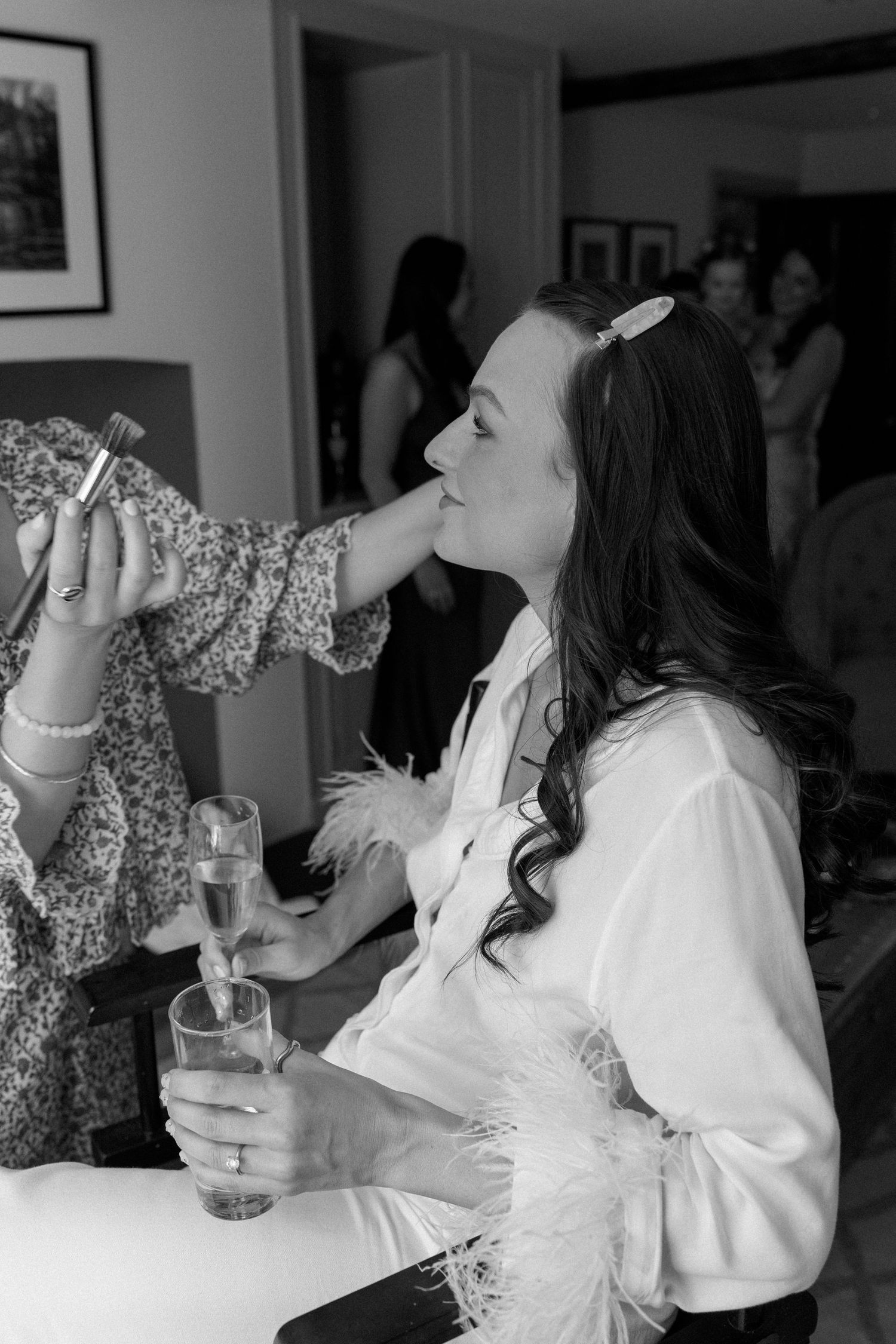Wedding party members taking celebratory shots at indoor reception.