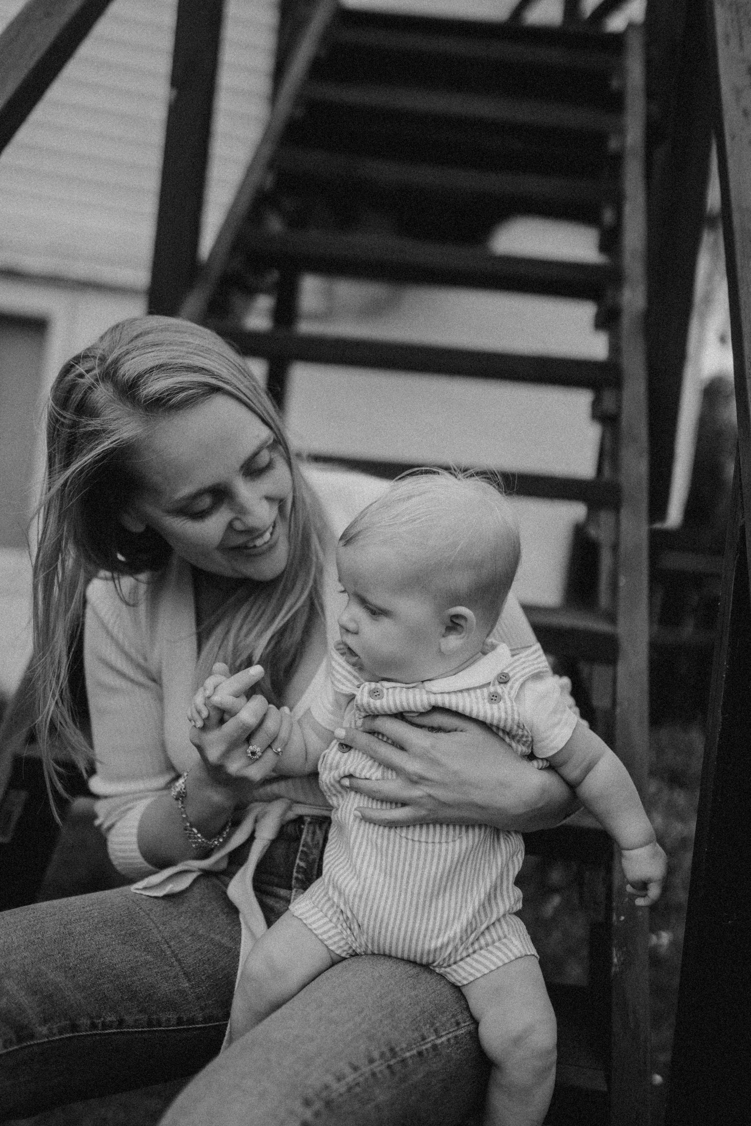 Candid family moment shared on wooden porch steps.
