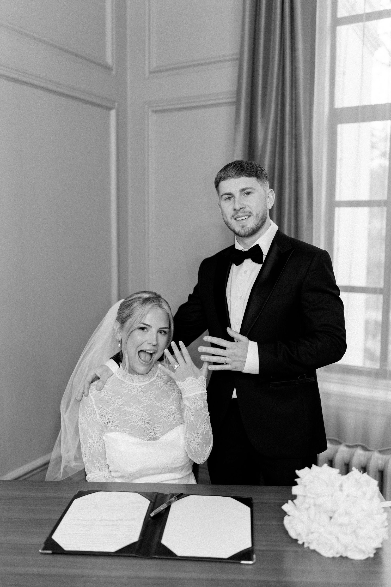 Black and white sequence of newlyweds sharing laughter during formal portraits.