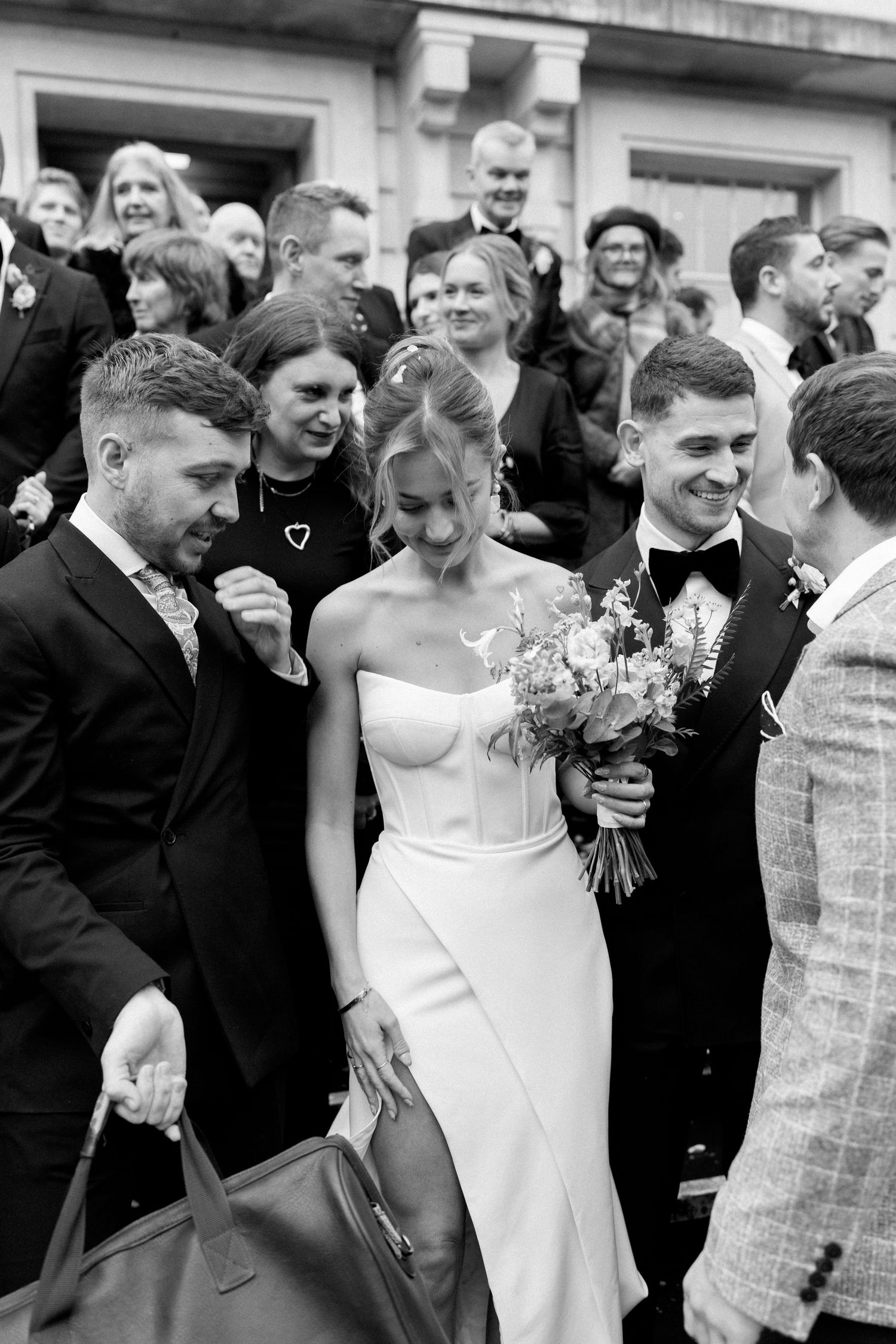 A sequence of black and white wedding photos showing joyful moments during a celebration.