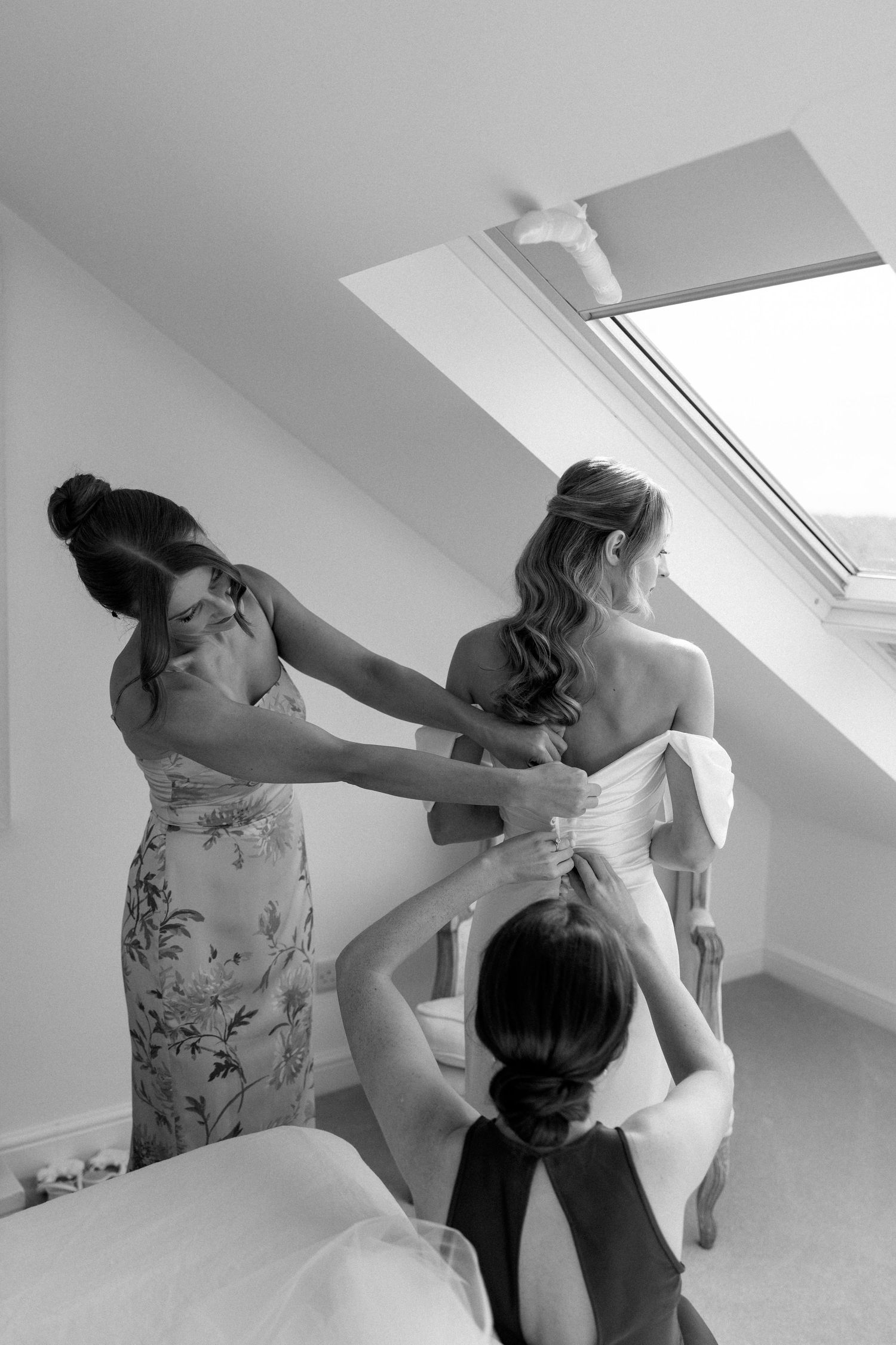 Sequence of someone getting ready in a bright attic room with white walls and skylights.