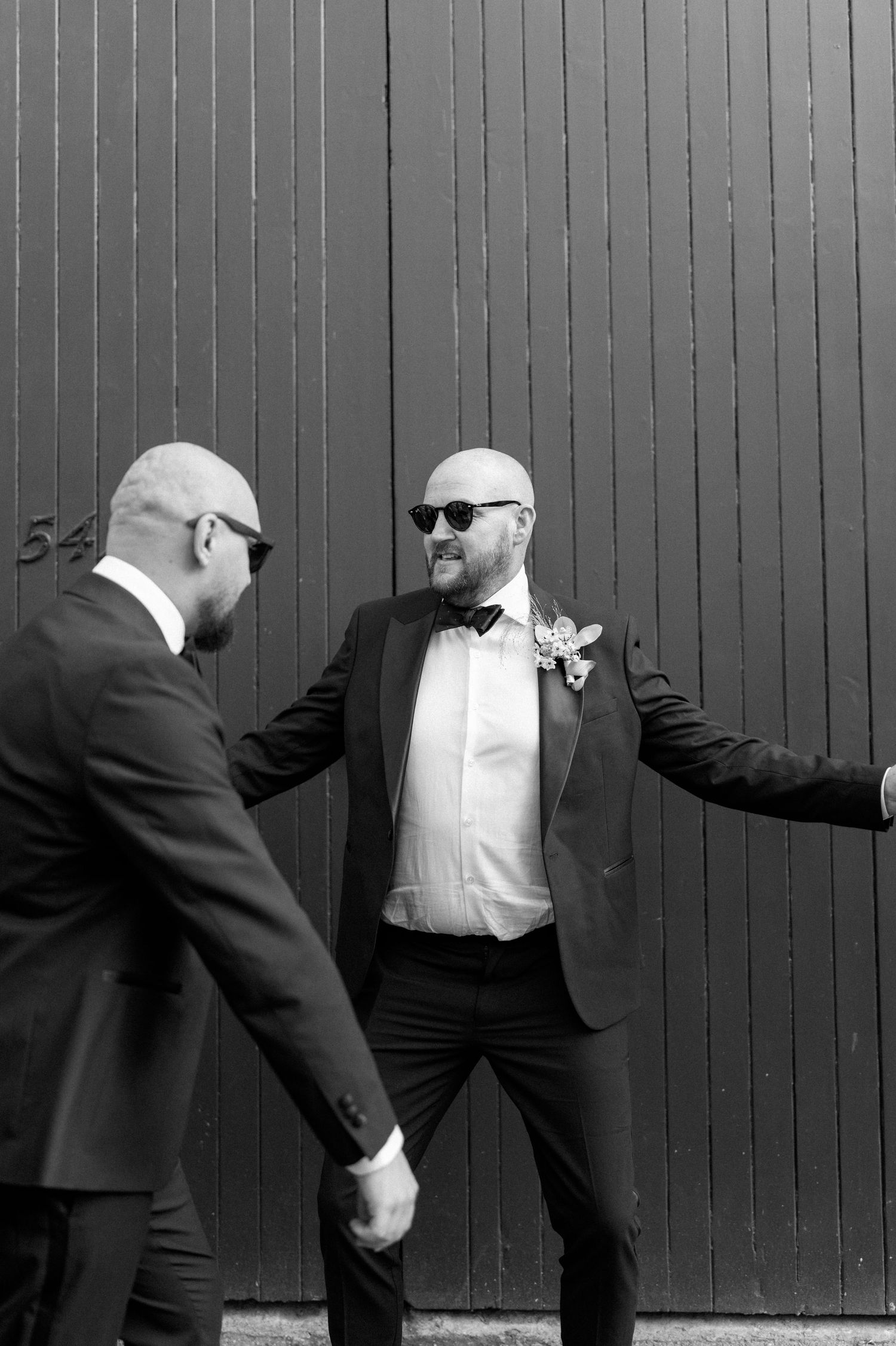 Black and white photos of people in formal wear posing playfully against a striped wall.
