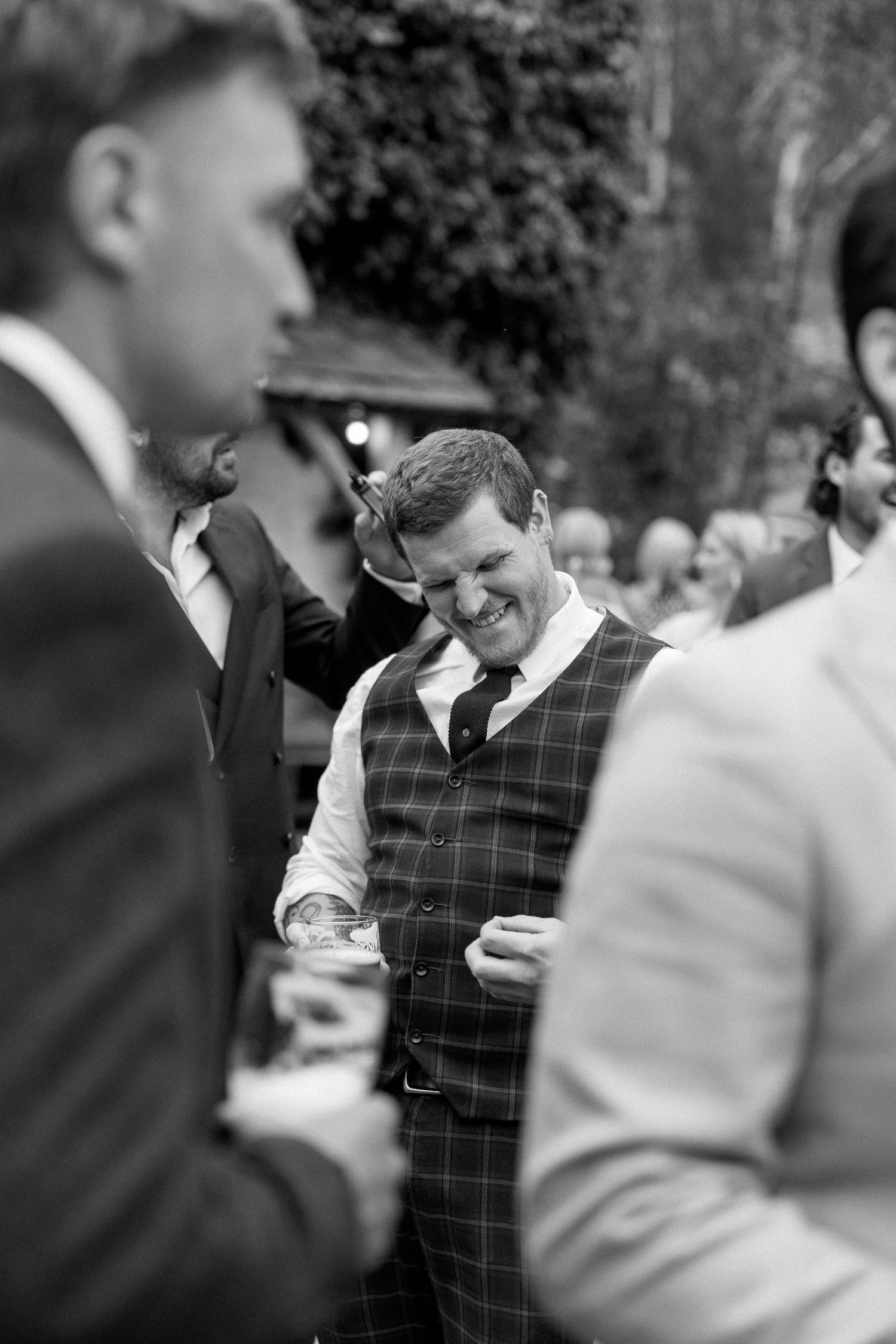 Guests enjoy themselves at an outdoor wedding celebration.