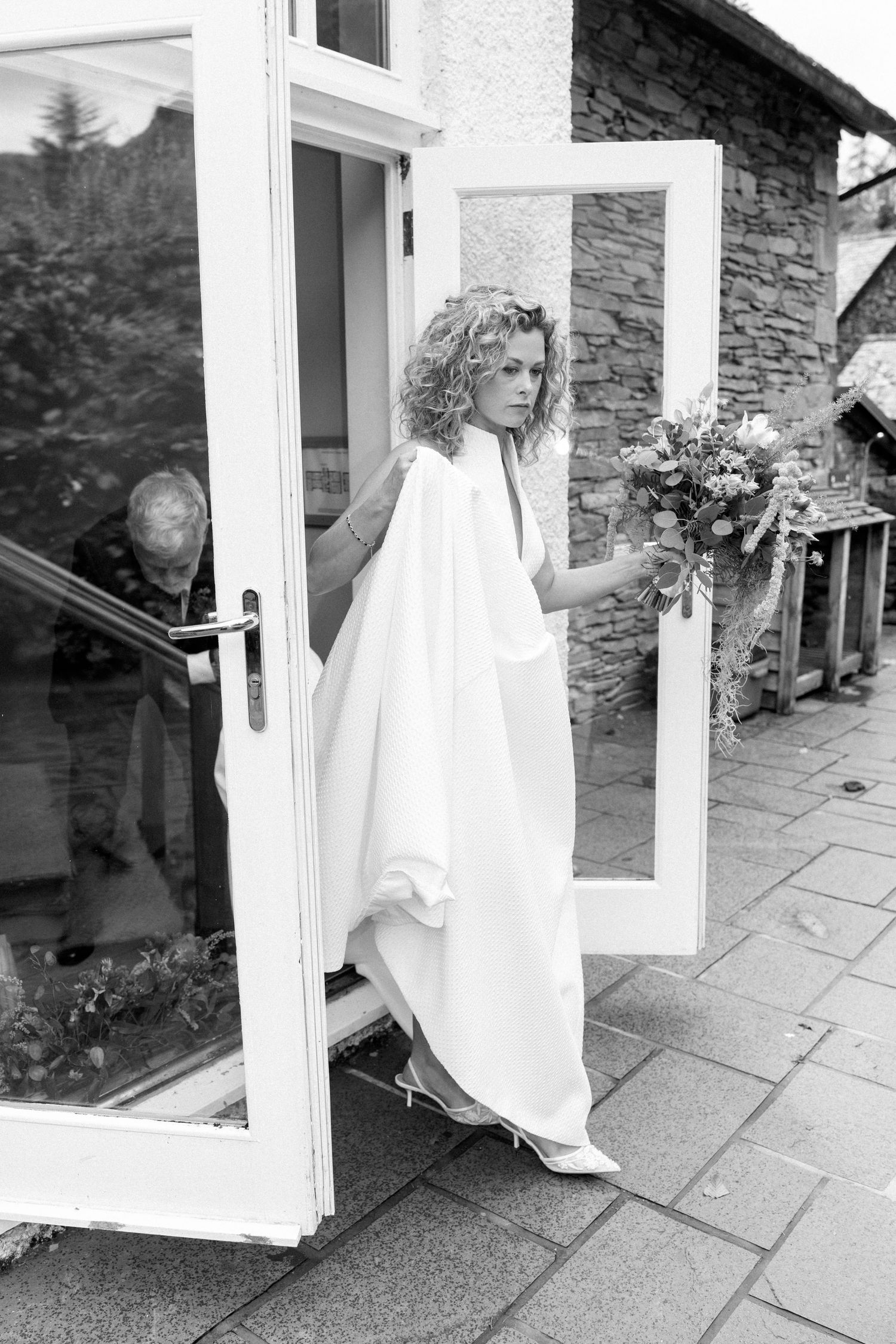 Black and white photo sequence showing a white wedding dress flowing through a window.