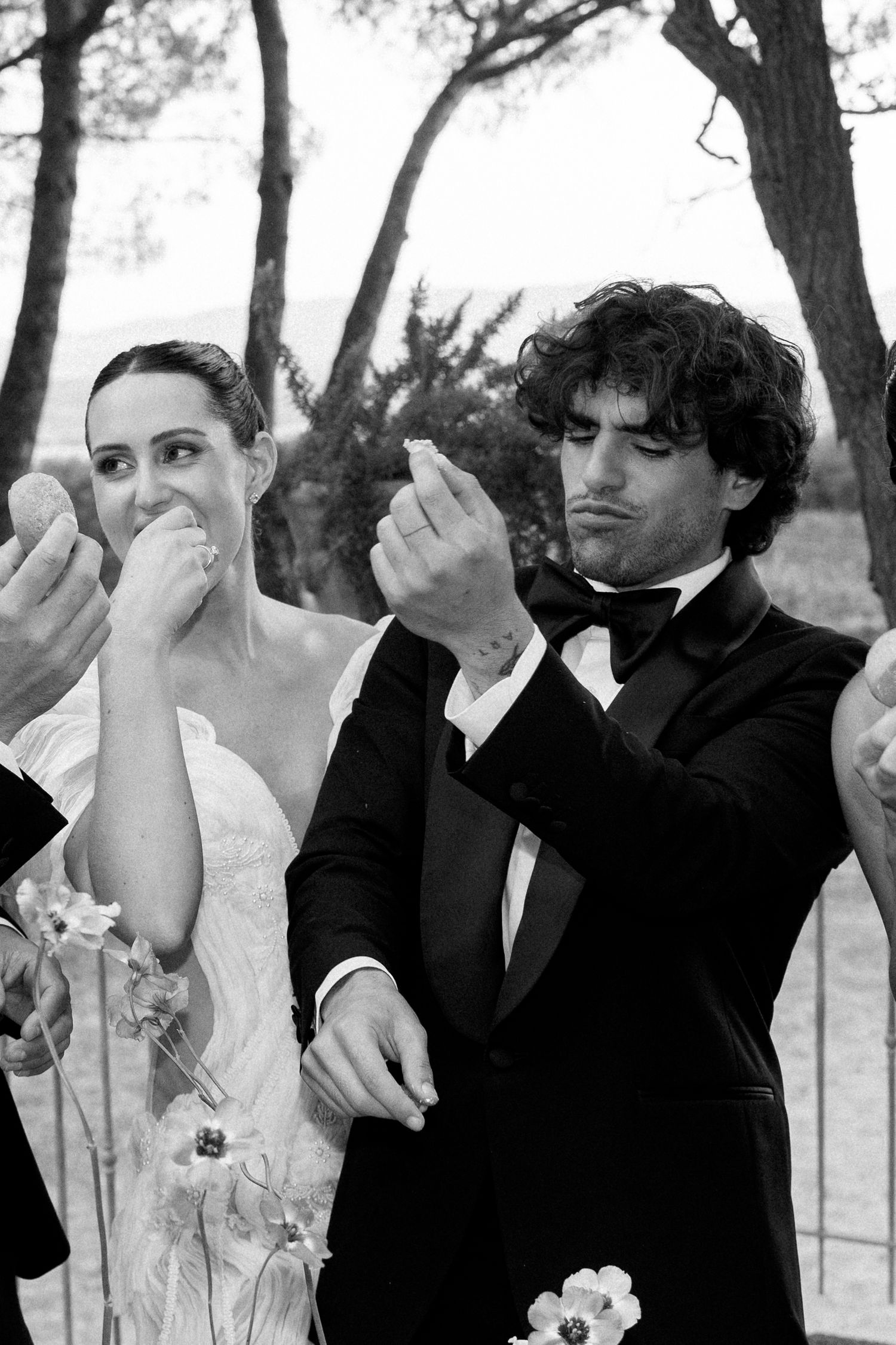 Wedding guests clapping and celebrating at outdoor ceremony.