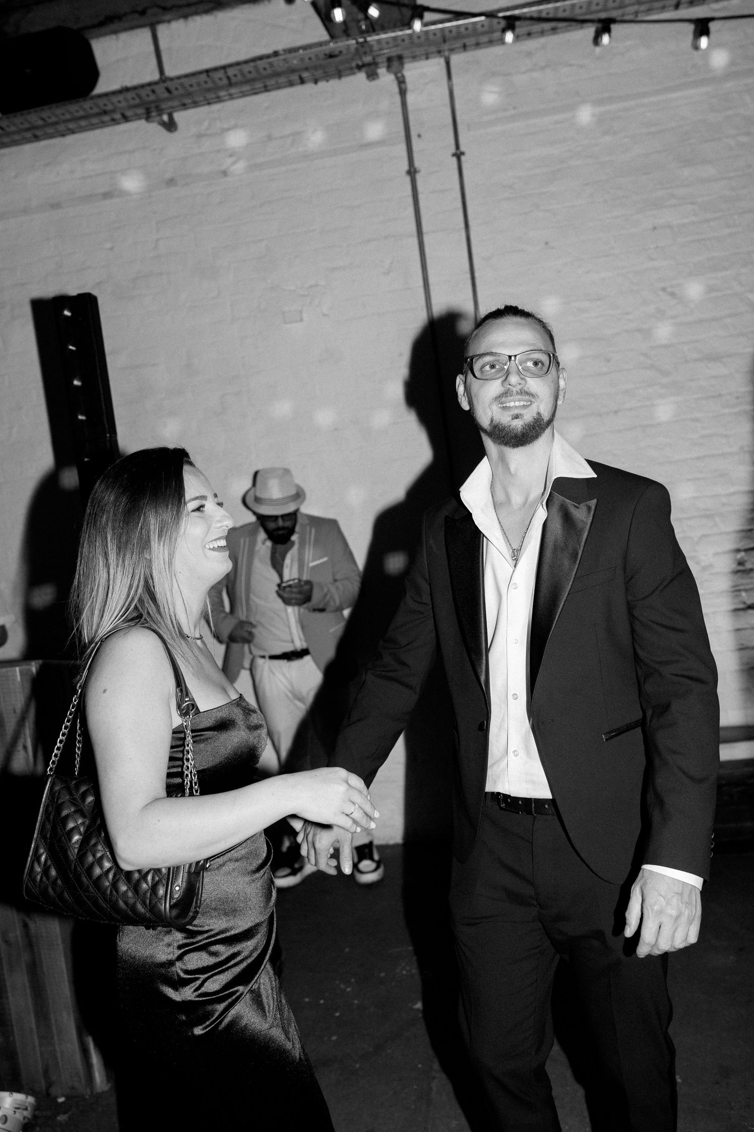 Black and white photos of party guests dancing and enjoying drinks at a celebration.