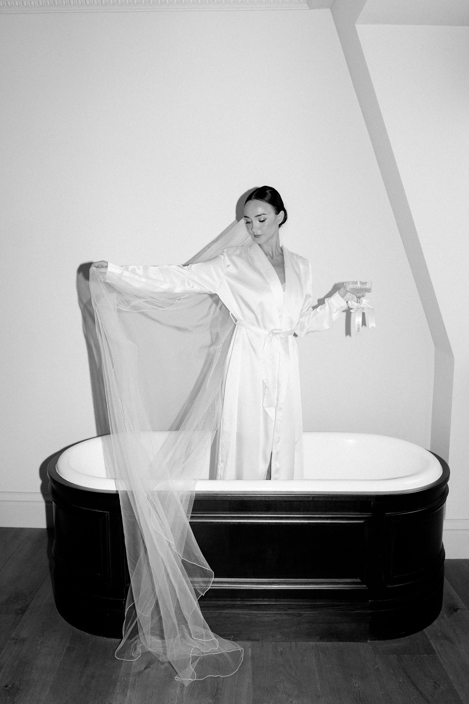 Artistic black and white photo sequence showing ethereal white fabric floating over a vintage bathtub.