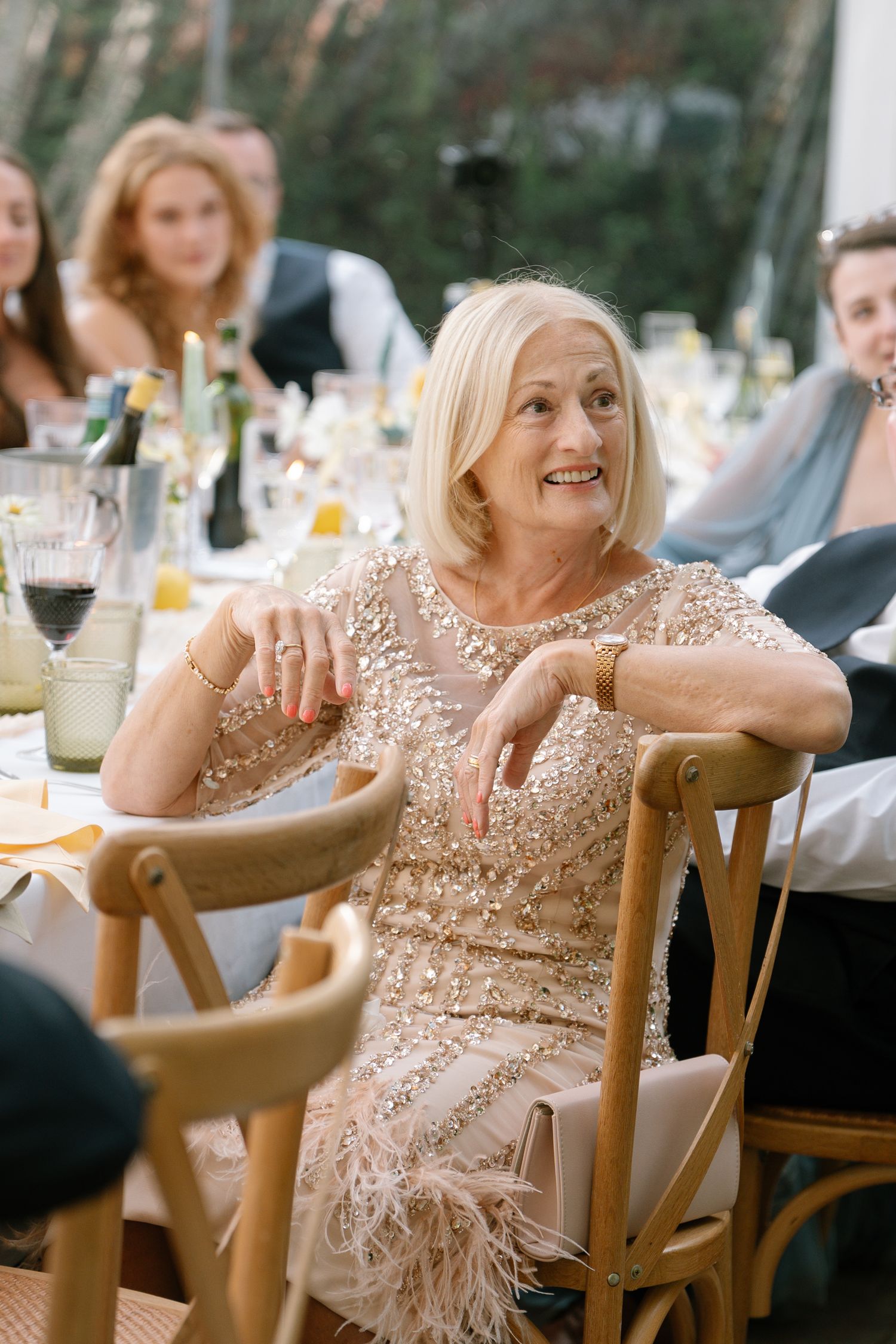 Guest in a sparkly beige dress enjoying the wedding reception festivities.