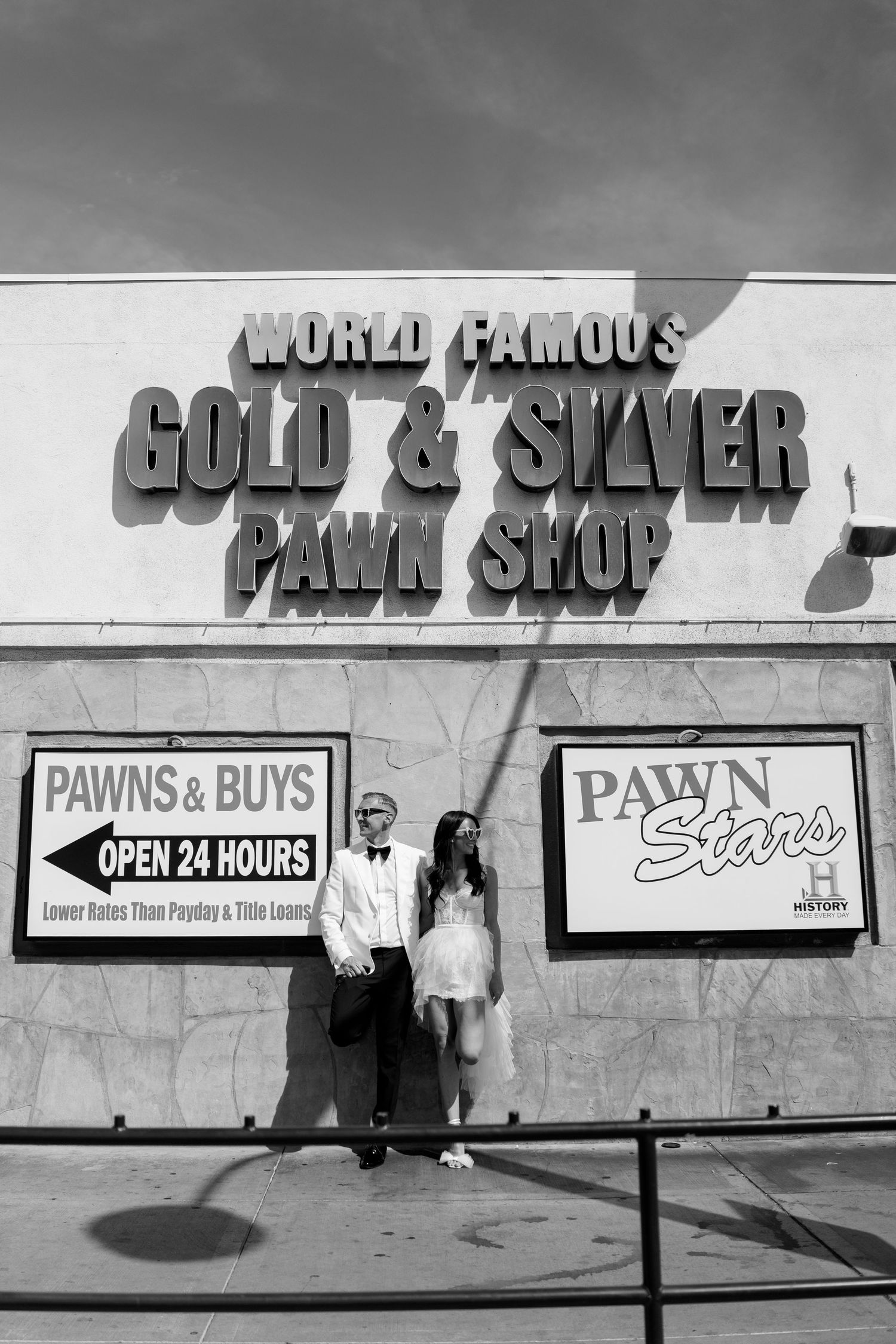 Storefront signs for a pawn shop advertising gold, silver, and 24-hour service.