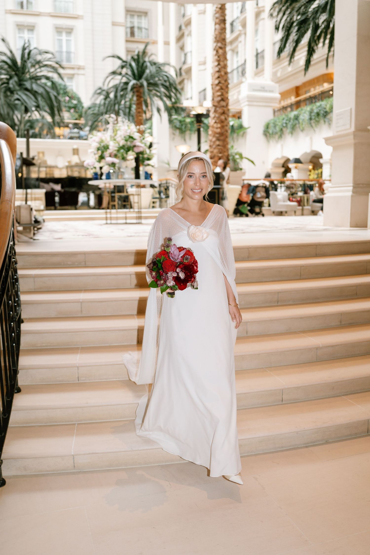 Bridal portrait series along luxurious marble steps with palm trees and columns in the background.