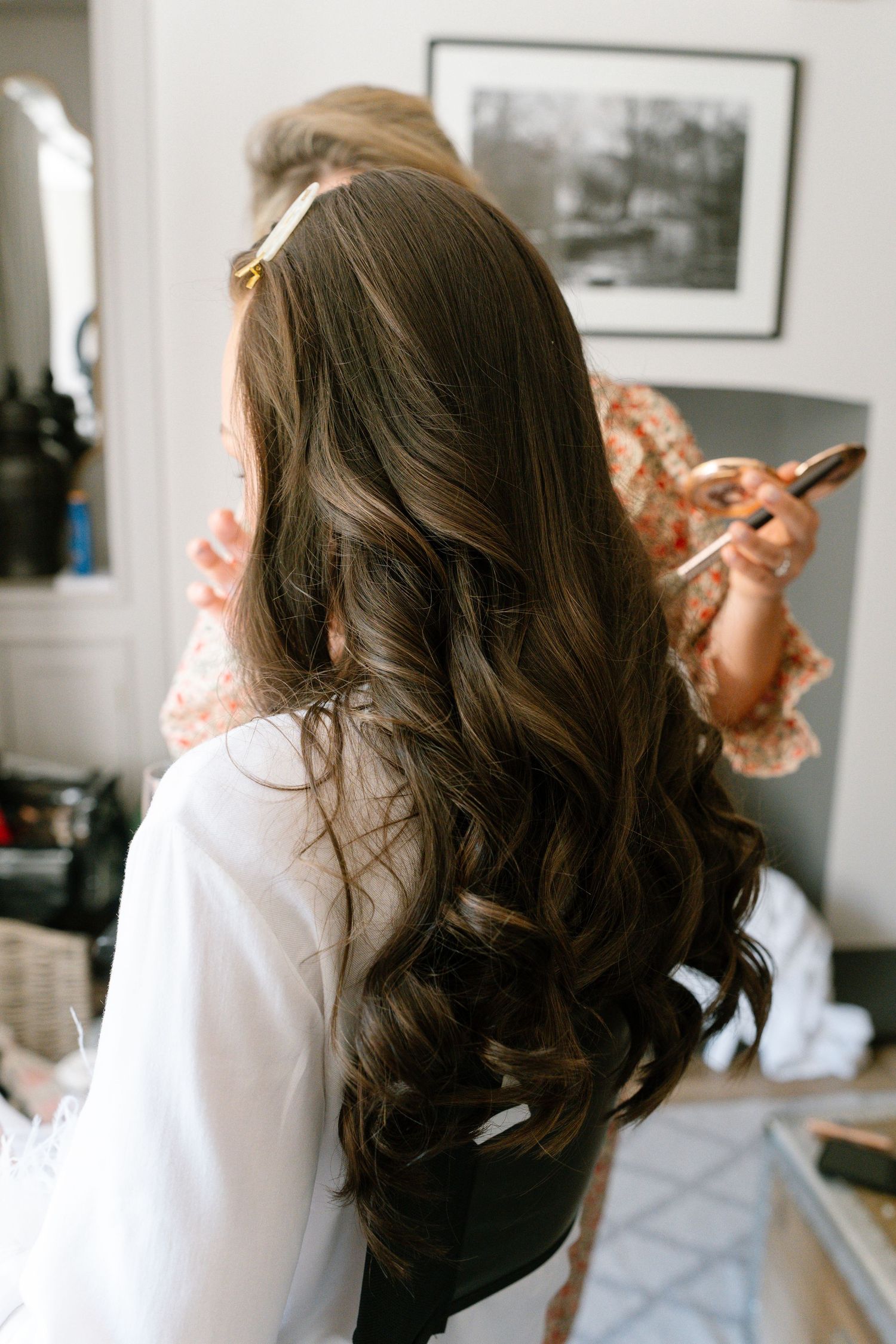 Long dark wavy hair being styled in a sequence of preparation shots.
