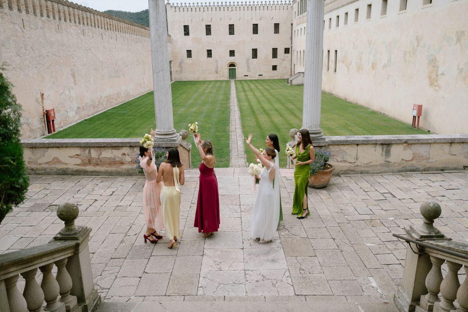 Panoramic view of historic venue with stone balustrades and manicured lawns.