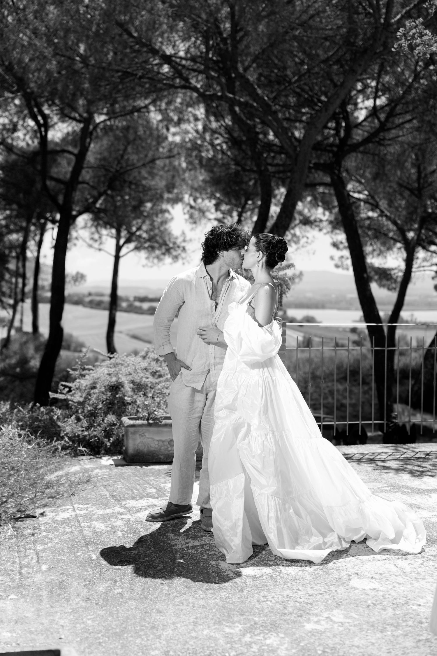Romantic outdoor wedding photoshoot in a sun-dappled garden setting.