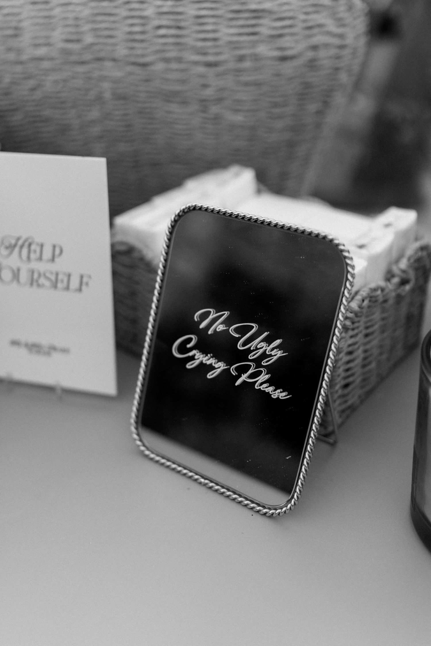 Elegant black mirrored sign reading No Ugly Crying Please displayed at wedding reception table.