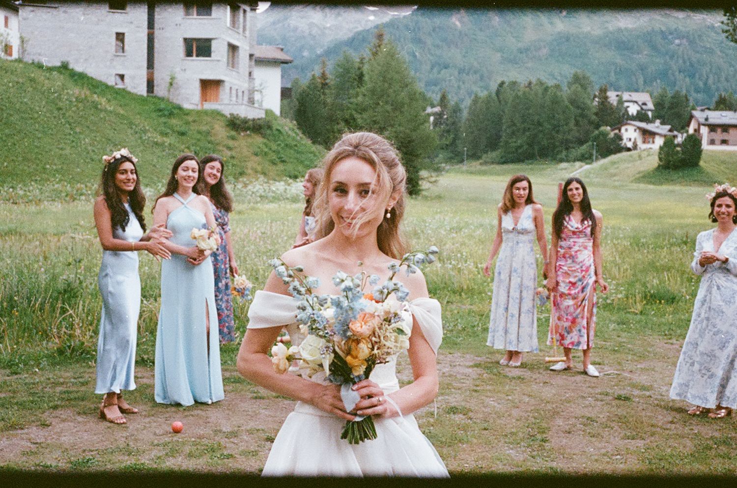 A collage of outdoor wedding party photos with people in pastel dresses standing in a scenic mountain setting.